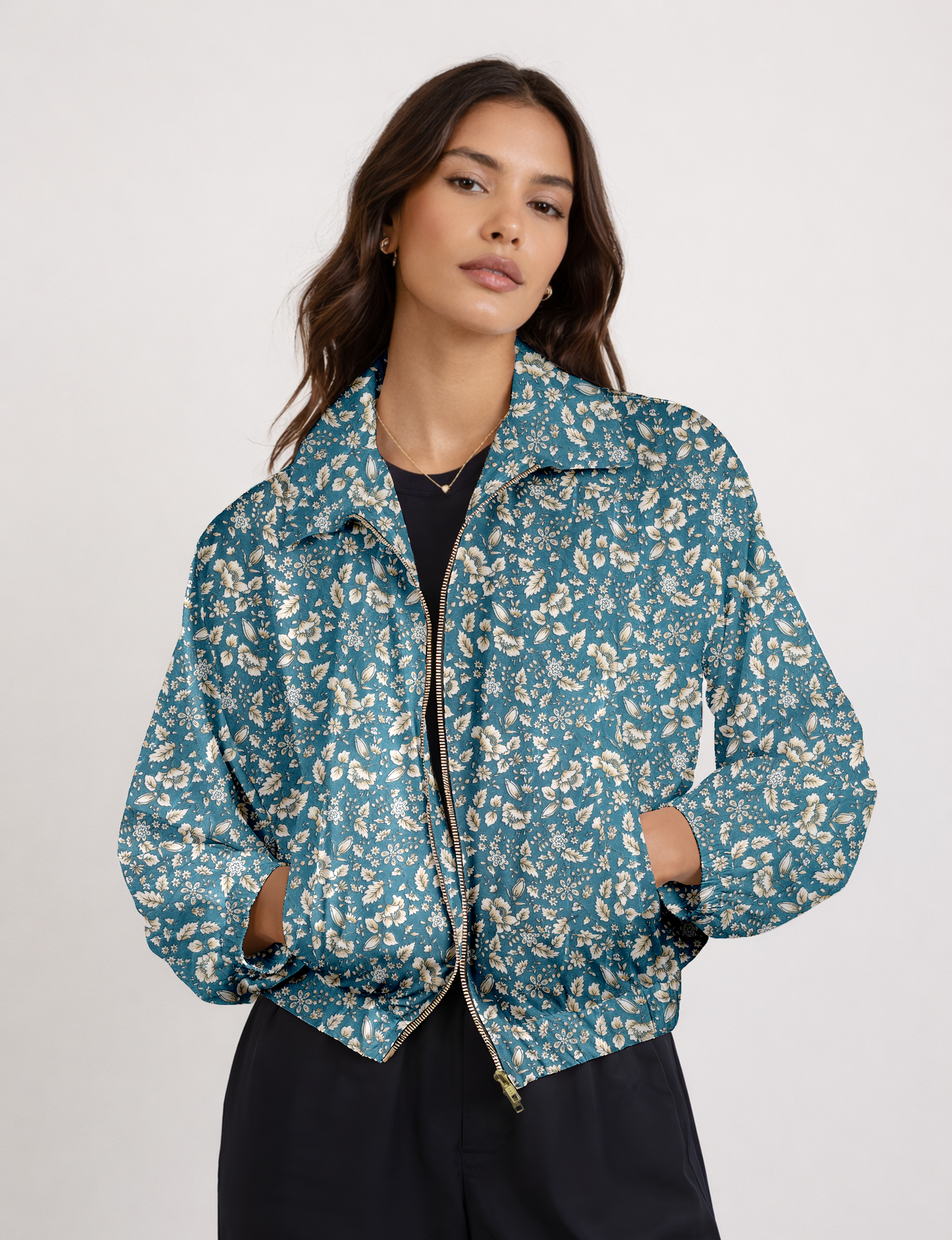 Women's cropped bomber jacket with twin metallic front zippers, welt pockets, elasticated hem and cuffs, and contrast sari print lining.