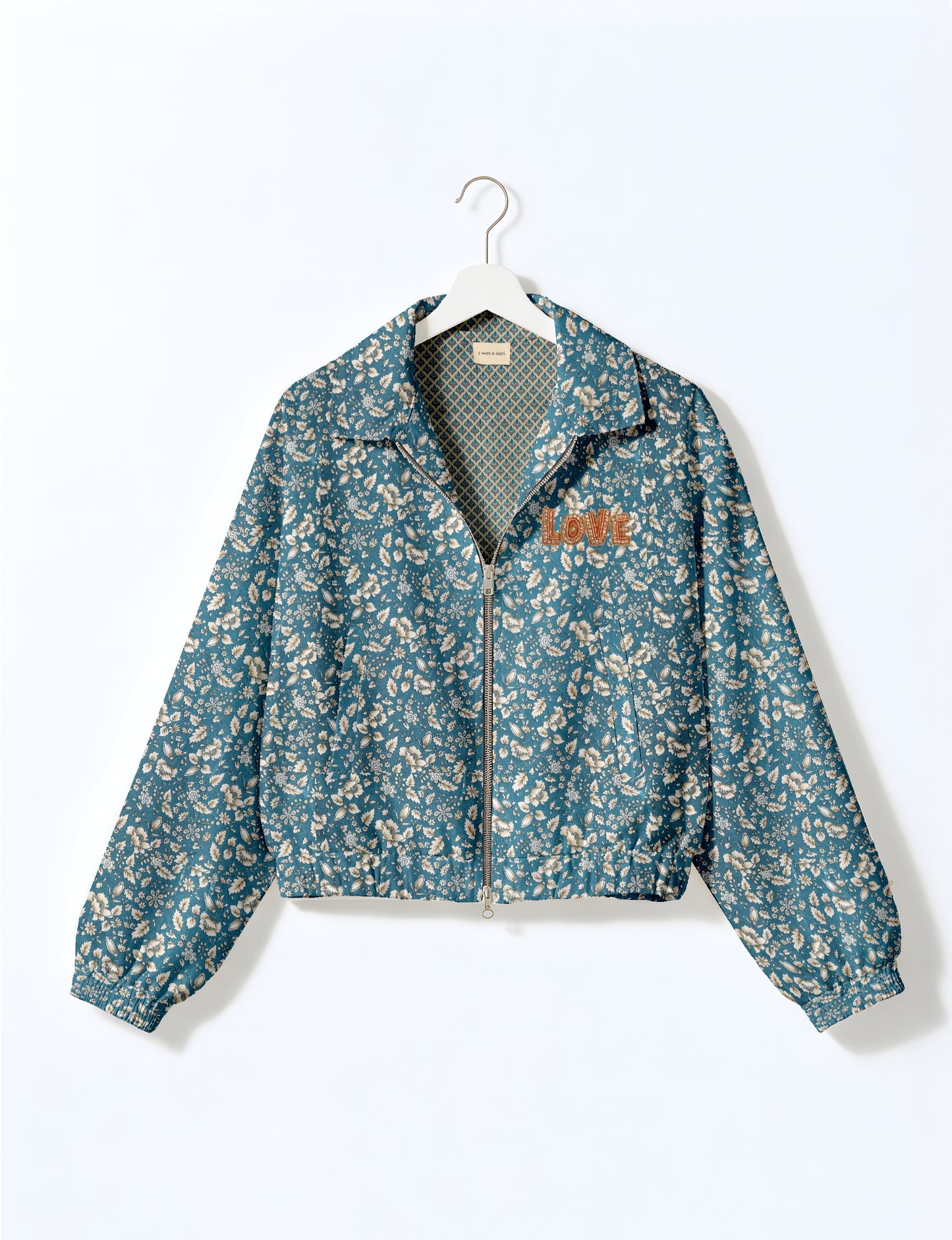 Love Bomber Jacket made from recycled fabric, featuring hand-stitched Aari embroidery. A unique piece of zero-waste clothing, part of the circular fashion movement. Designed with upcycled materials for a stylish yet environmentally friendly clothing choice.