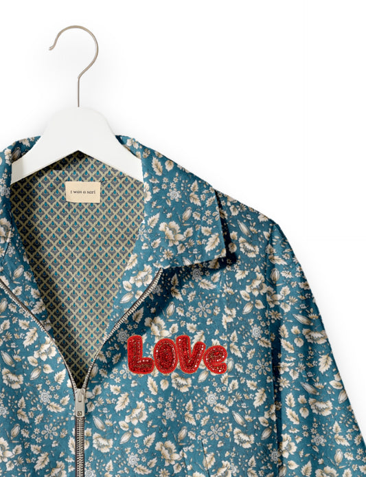 Love Bomber Jacket made from recycled fabric, featuring hand-stitched Aari embroidery. A unique piece of zero-waste clothing, part of the circular fashion movement. Designed with upcycled materials for a stylish yet environmentally friendly clothing choice.