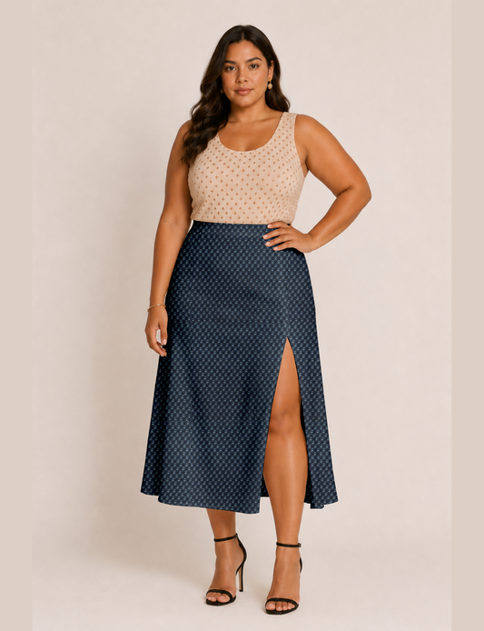 Woman wearing a yellow and black micro patterned A-line skirt with front slit, paired with beige sleeveless top and black