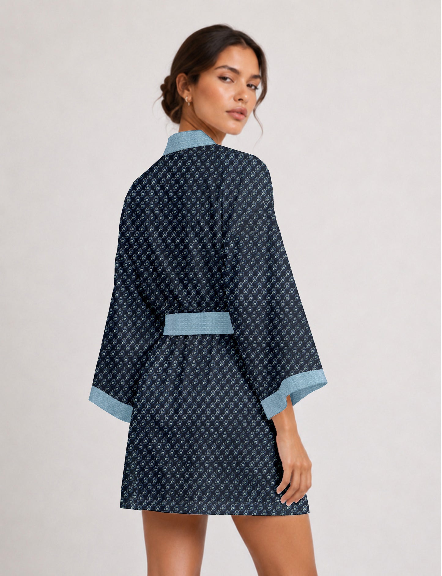 Short kimono robe with wrap front, V-neckline, wide sleeves, waist tie, and concealed skort detail.
