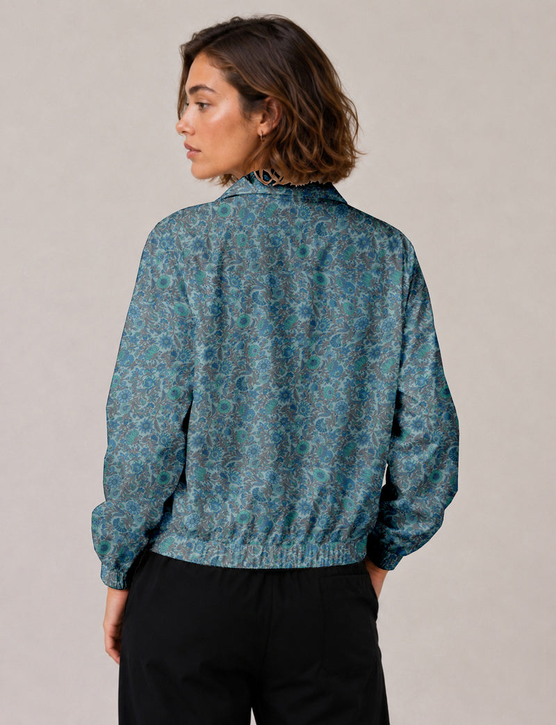 Brown floral bomber jacket with front zipper, elastic cuffs and hem, hanging on white hanger, red floral inner lining visible