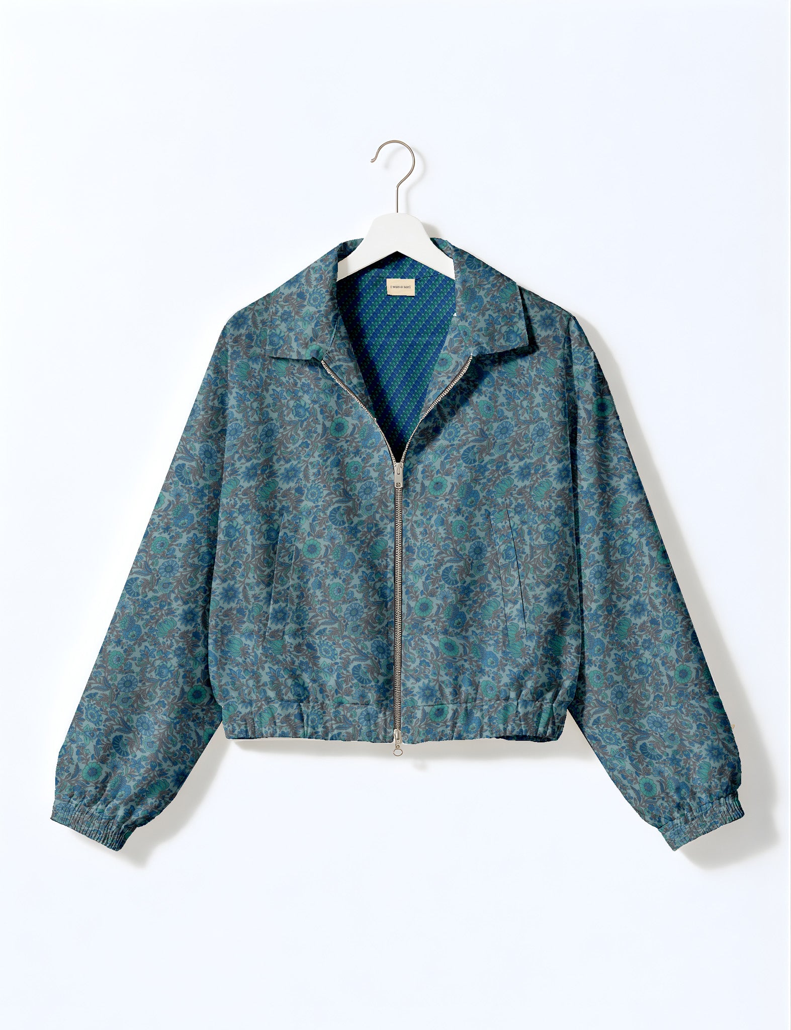 Woman wearing a yellow floral bomber jacket with front zipper, elastic cuffs, and side pockets, shown from front view