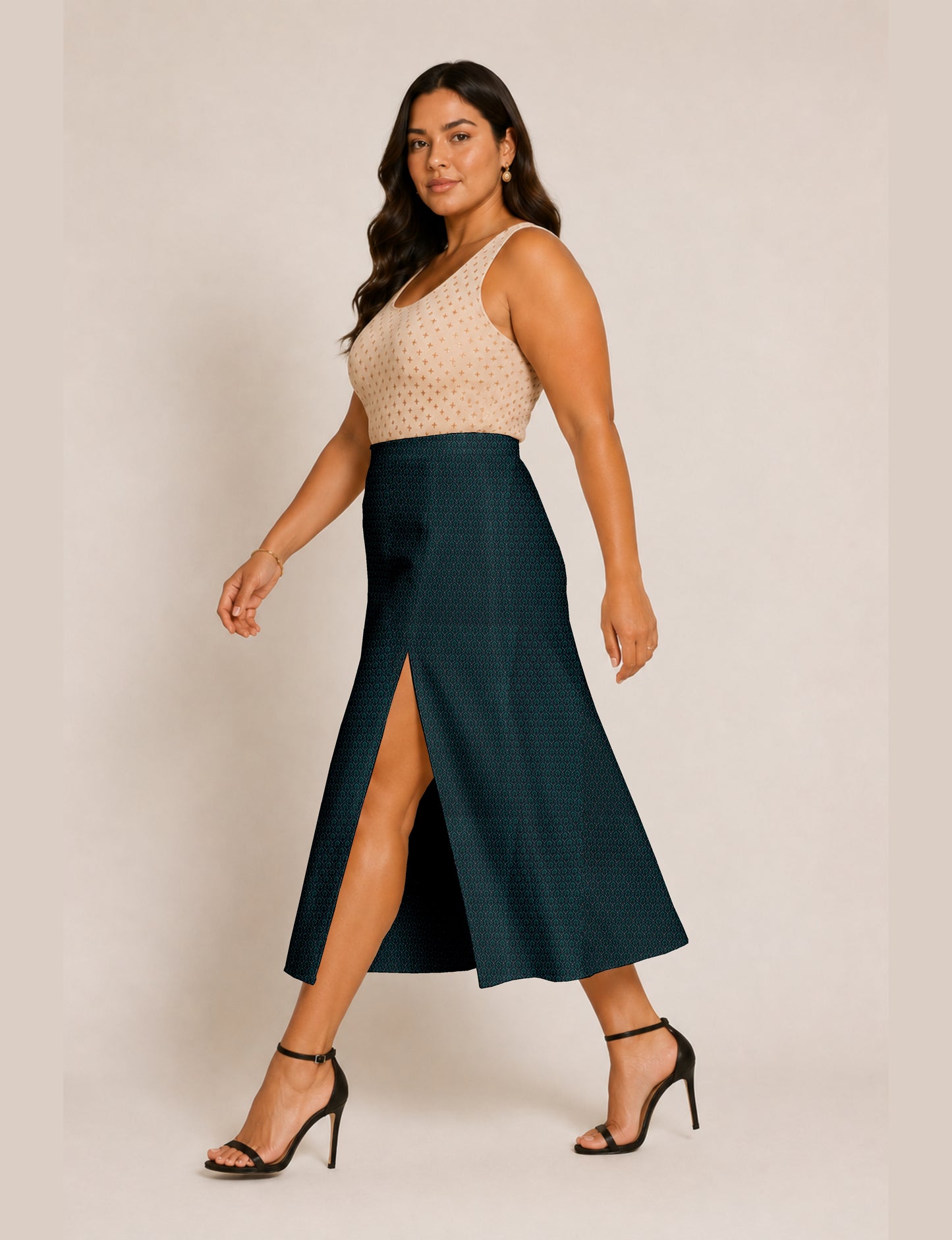 Woman wearing a yellow and black micro patterned A-line skirt with front slit, paired with beige sleeveless top and black