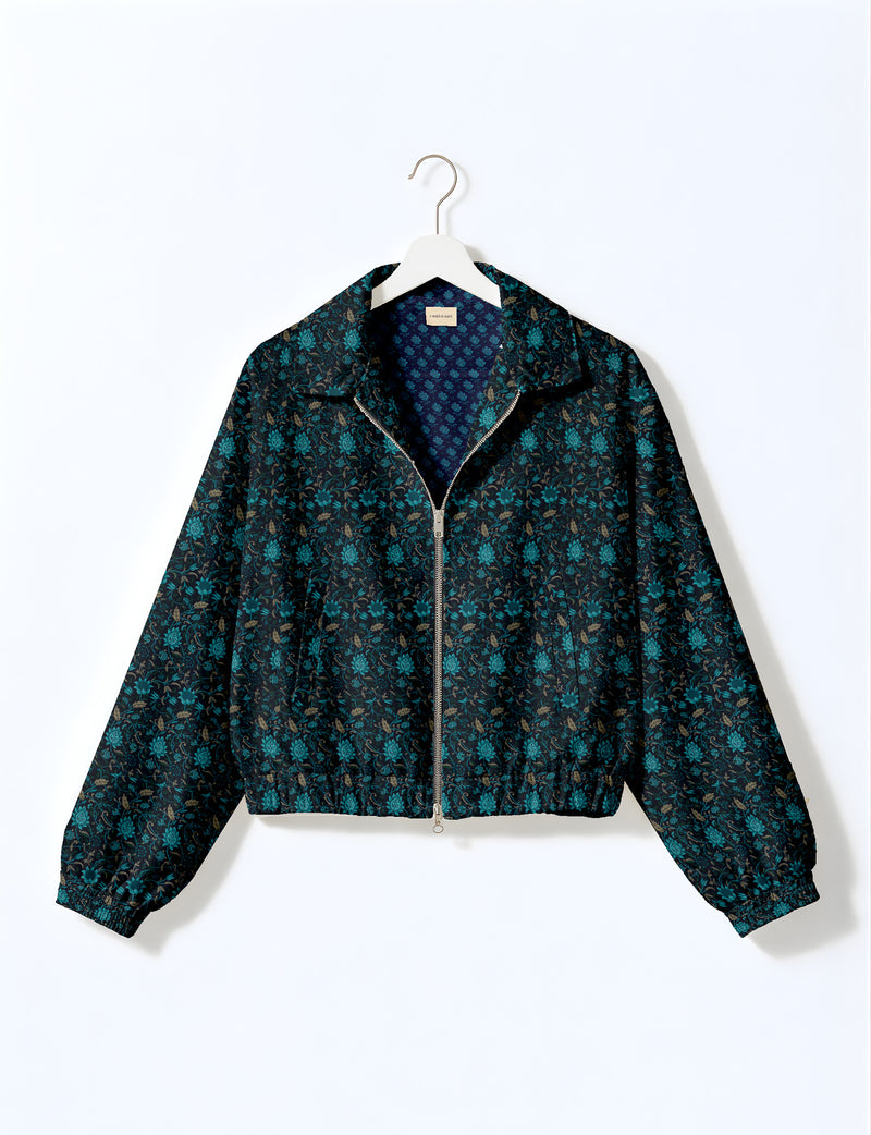 Brown floral bomber jacket with front zipper, elastic cuffs and hem, hanging on white hanger, red floral inner lining visible