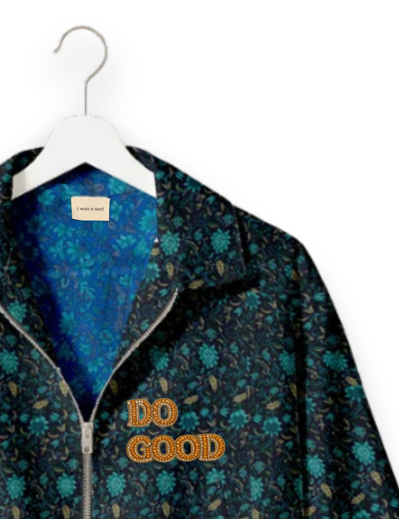 Gold cropped DO GOOD bomber jacket featuring hand-embroidered lettering on the left chest, contrasting inner lining and two functional pockets.