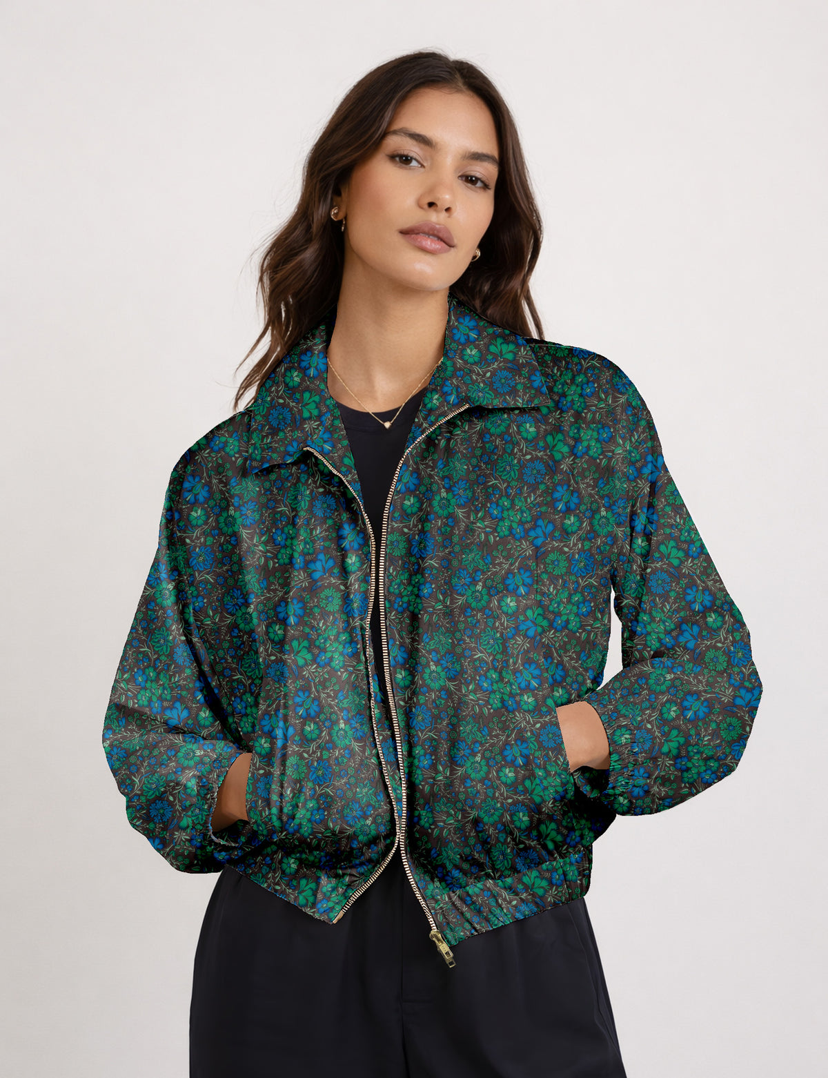 Brown floral bomber jacket with front zipper, elastic cuffs and hem, hanging on white hanger, red floral inner lining visible