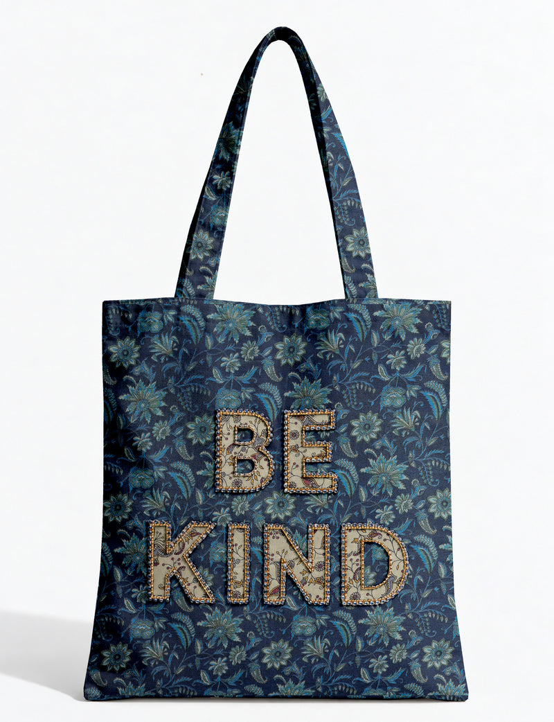 Be Kind tote bag with contrast sari fabric appliqué lettering, double shoulder straps, and front slip pocket.