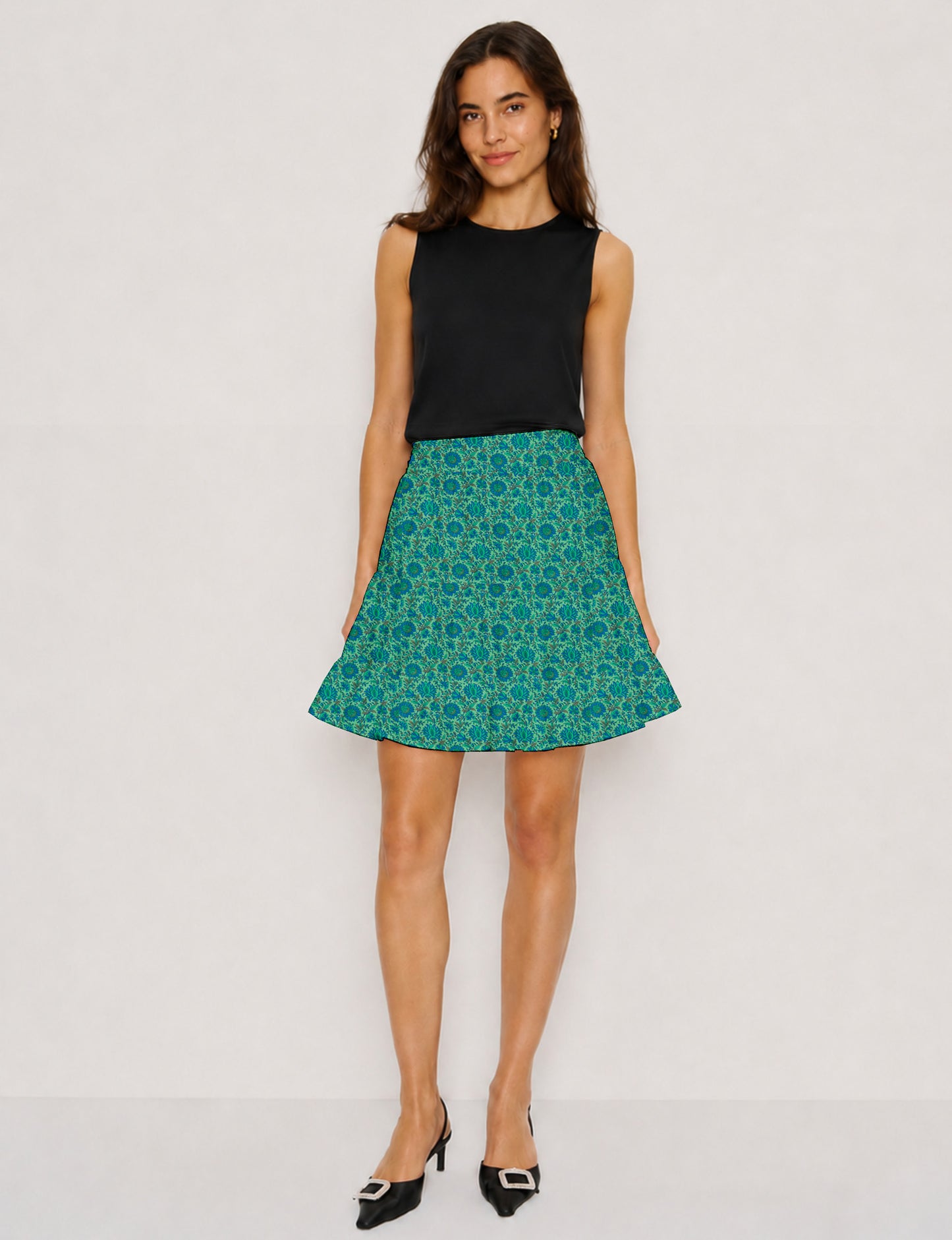Short tiered skirt with a fitted waistband, knife pleats, softly flared silhouette, side seam pockets, and above-the-knee length.