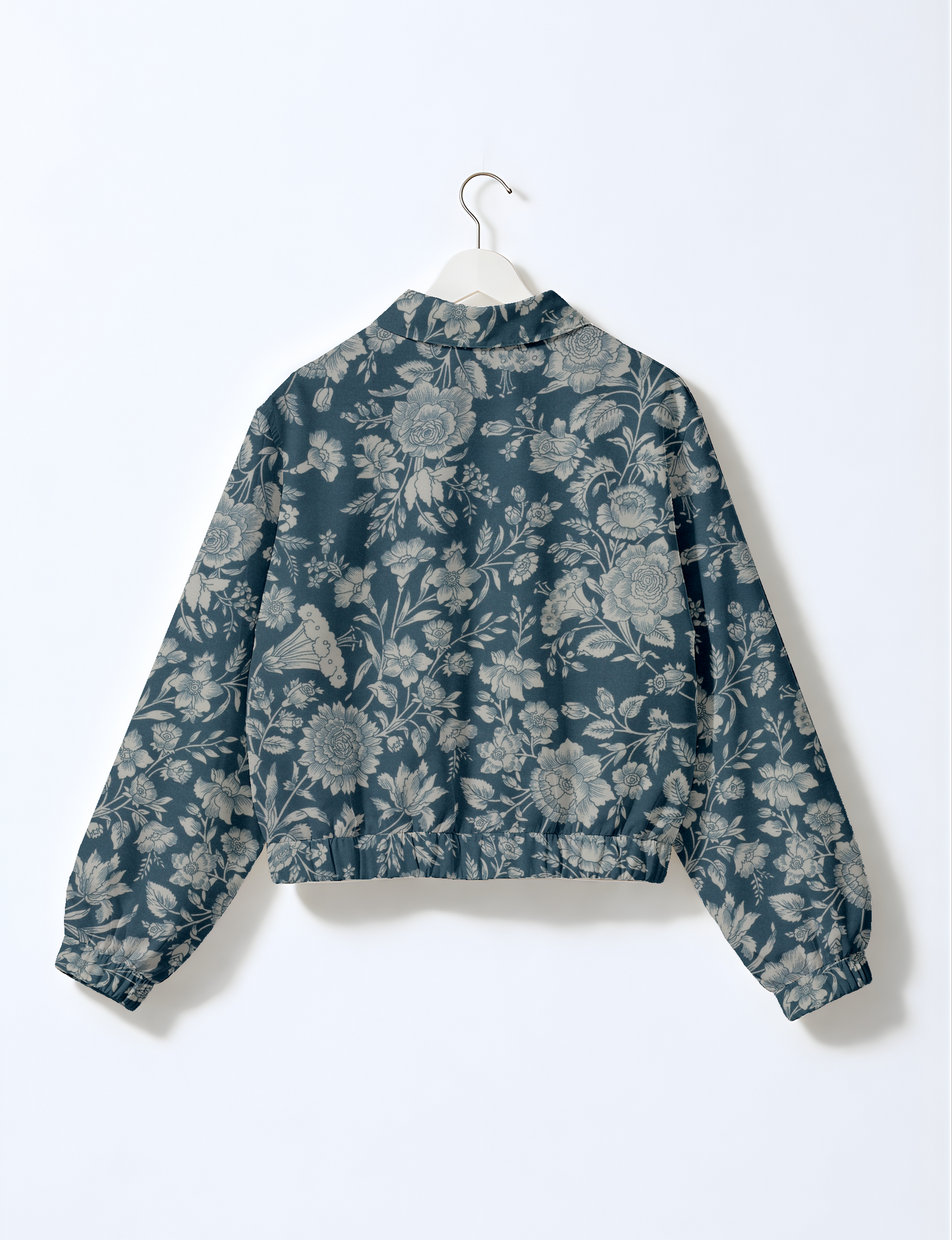 Women's cropped bomber jacket with twin metallic front zippers, welt pockets, elasticated hem and cuffs, and contrast sari print lining.