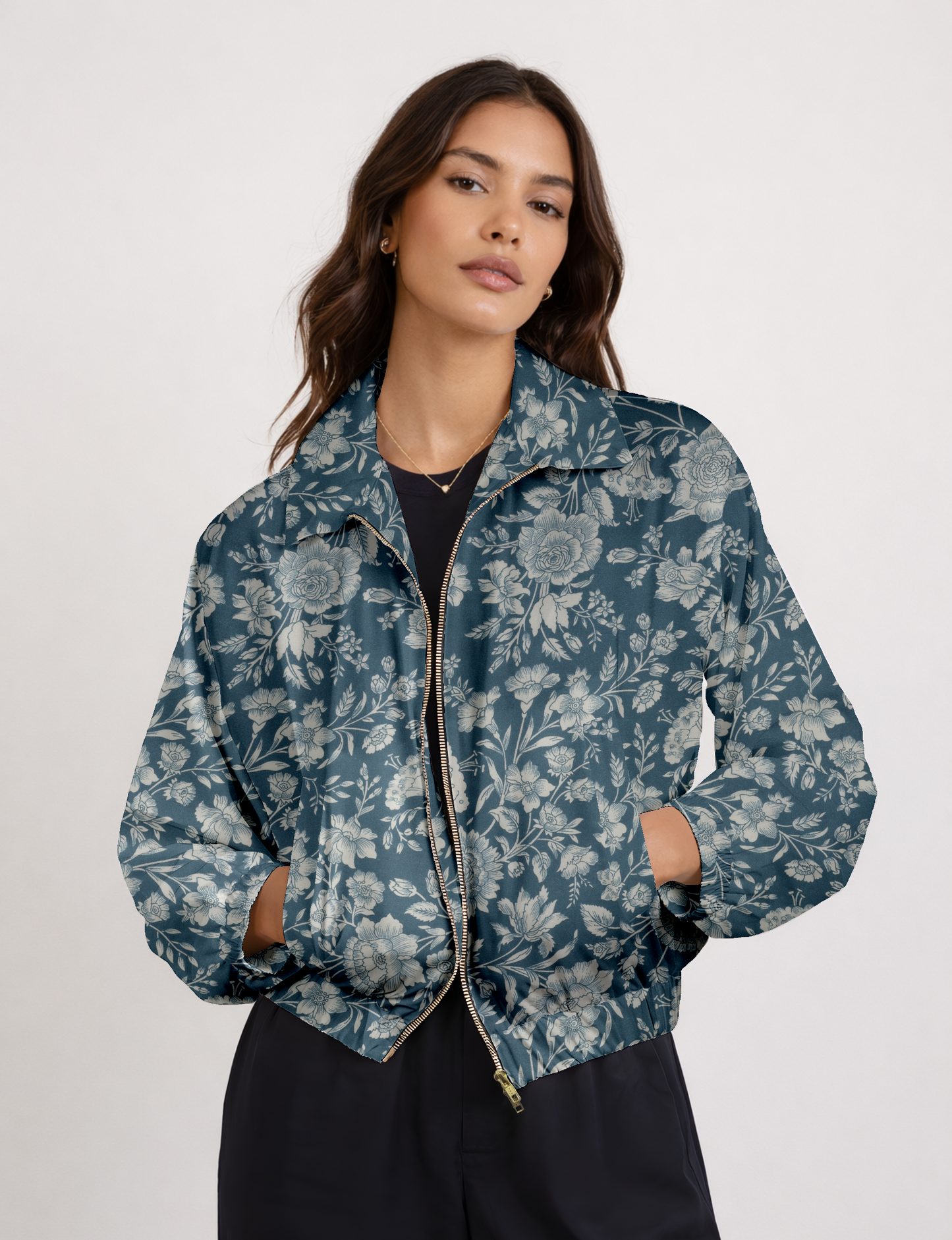 Women's cropped bomber jacket with twin metallic front zippers, welt pockets, elasticated hem and cuffs, and contrast sari print lining.