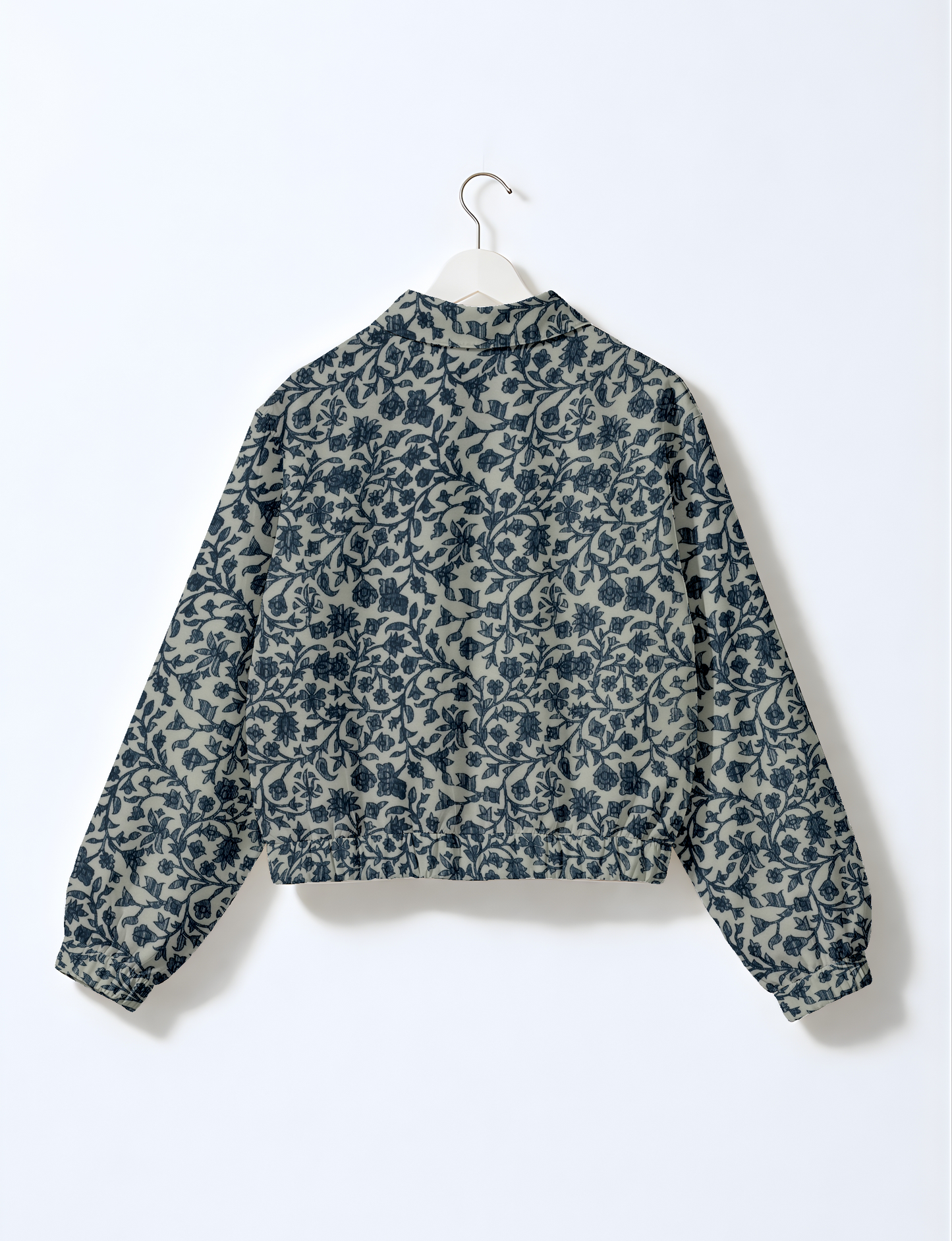 Women's cropped bomber jacket with twin metallic front zippers, welt pockets, elasticated hem and cuffs, and contrast sari print lining.