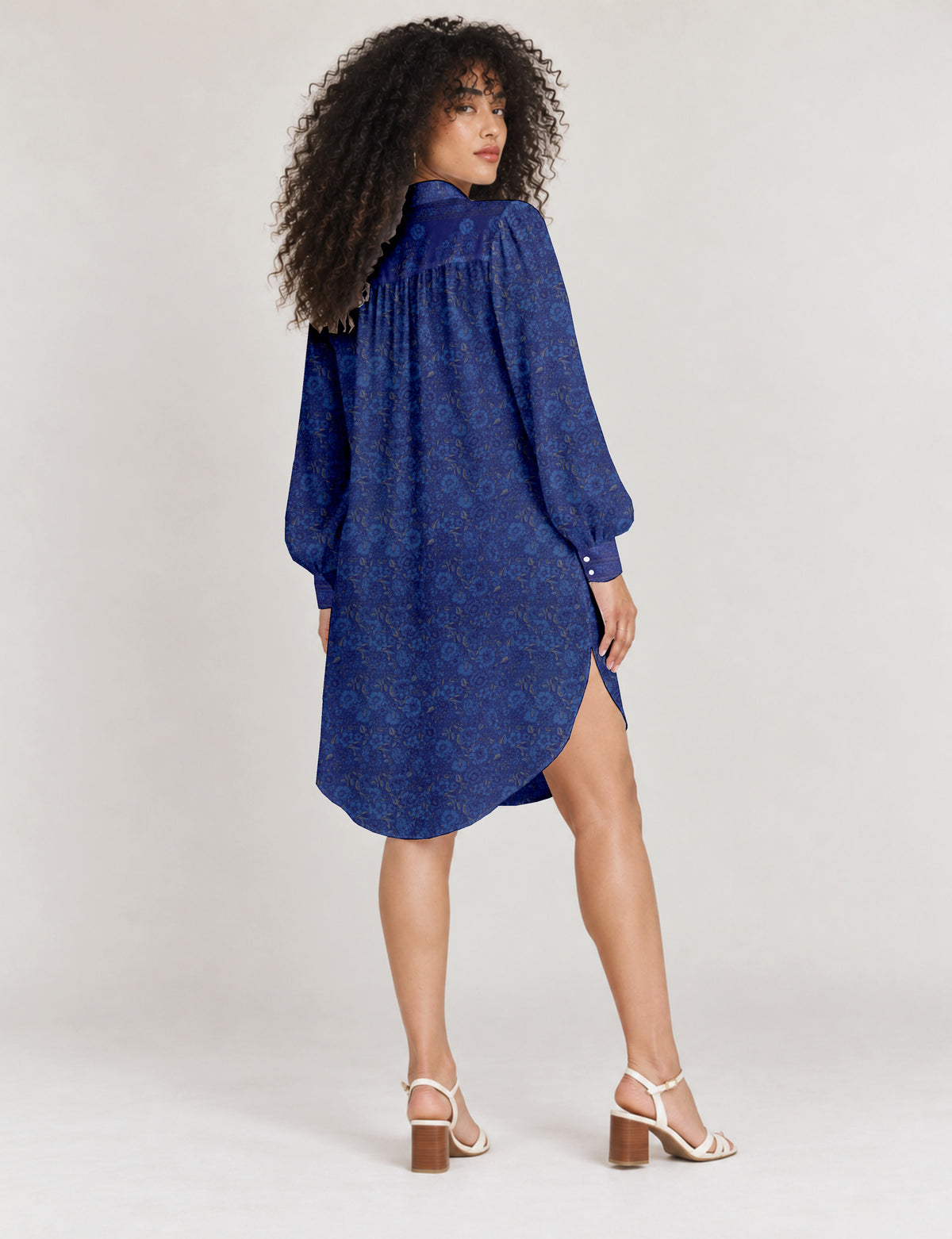 High low shirt with a relaxed fit, button-down front, classic collar, gathered shoulders and full-length blouson sleeves.