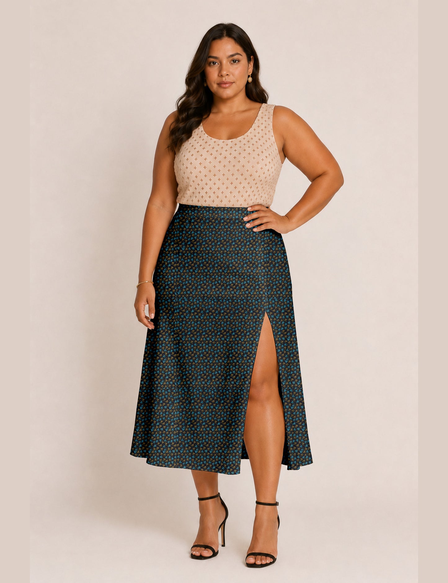 Woman wearing a yellow and black micro patterned A-line skirt with front slit, paired with beige sleeveless top and black