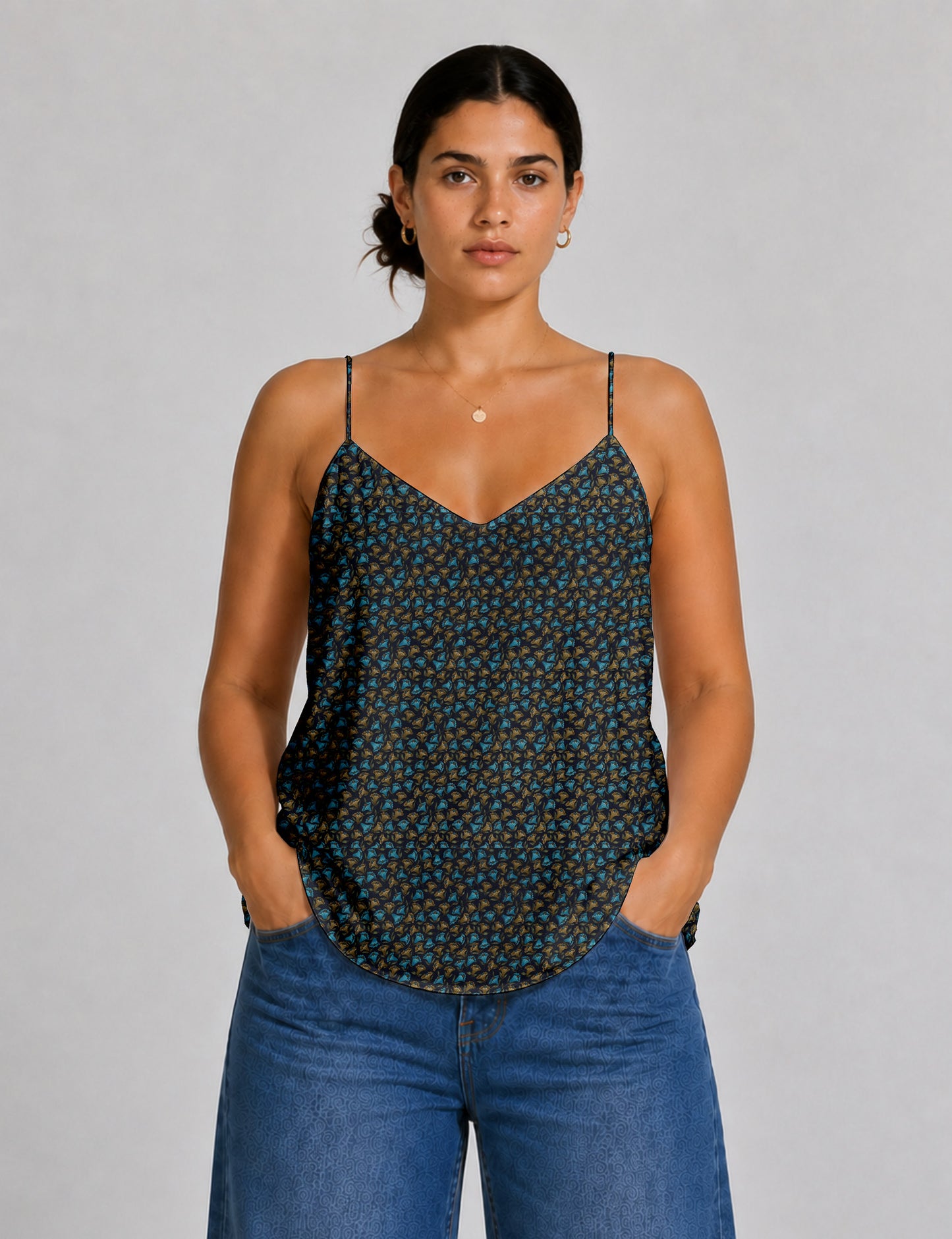 Women's sleeveless slip top with a relaxed straight fit, soft V-neckline, deep V-back, and delicate spaghetti straps.