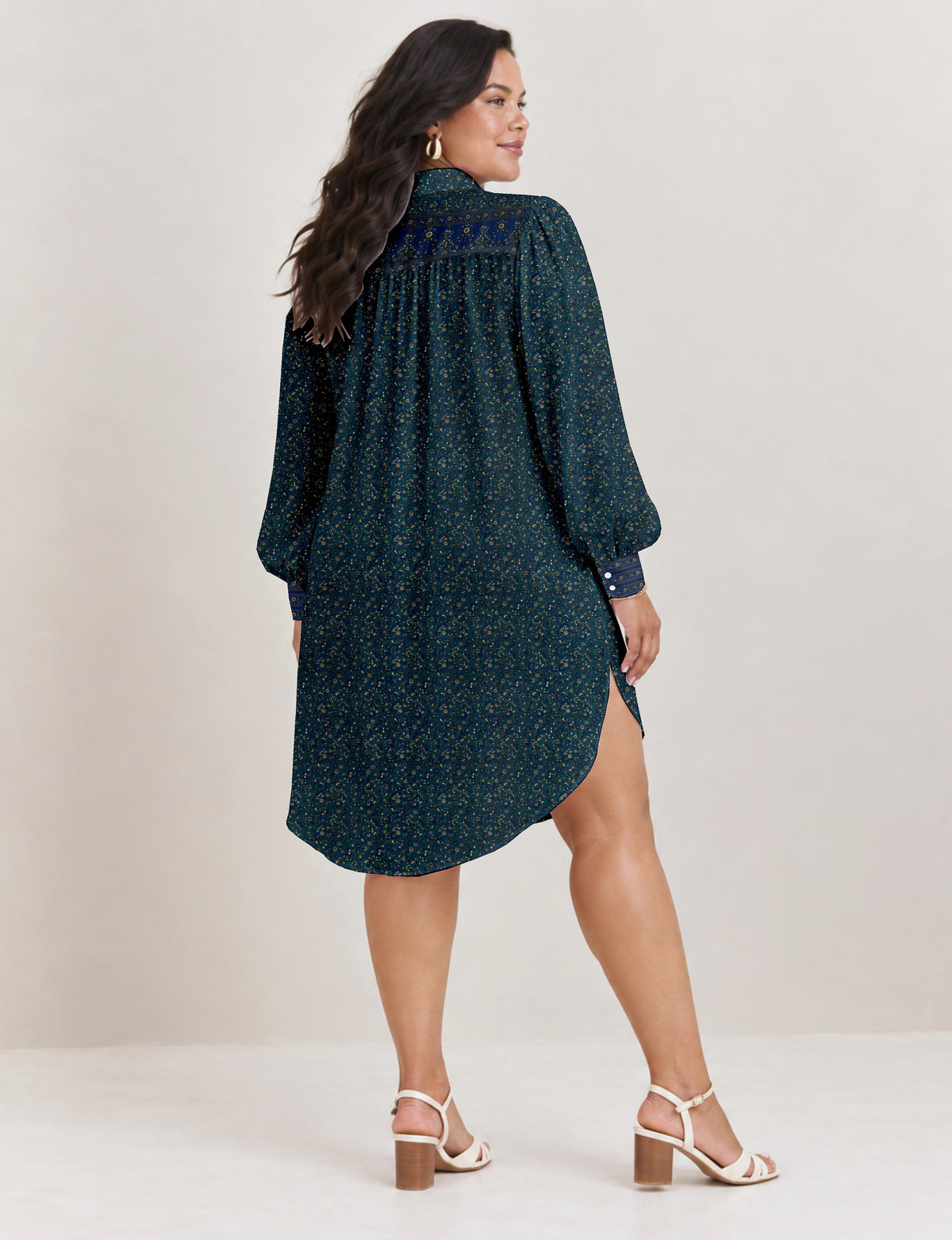 High low shirt with a relaxed fit, button-down front, classic collar, gathered shoulders and full-length blouson sleeves.