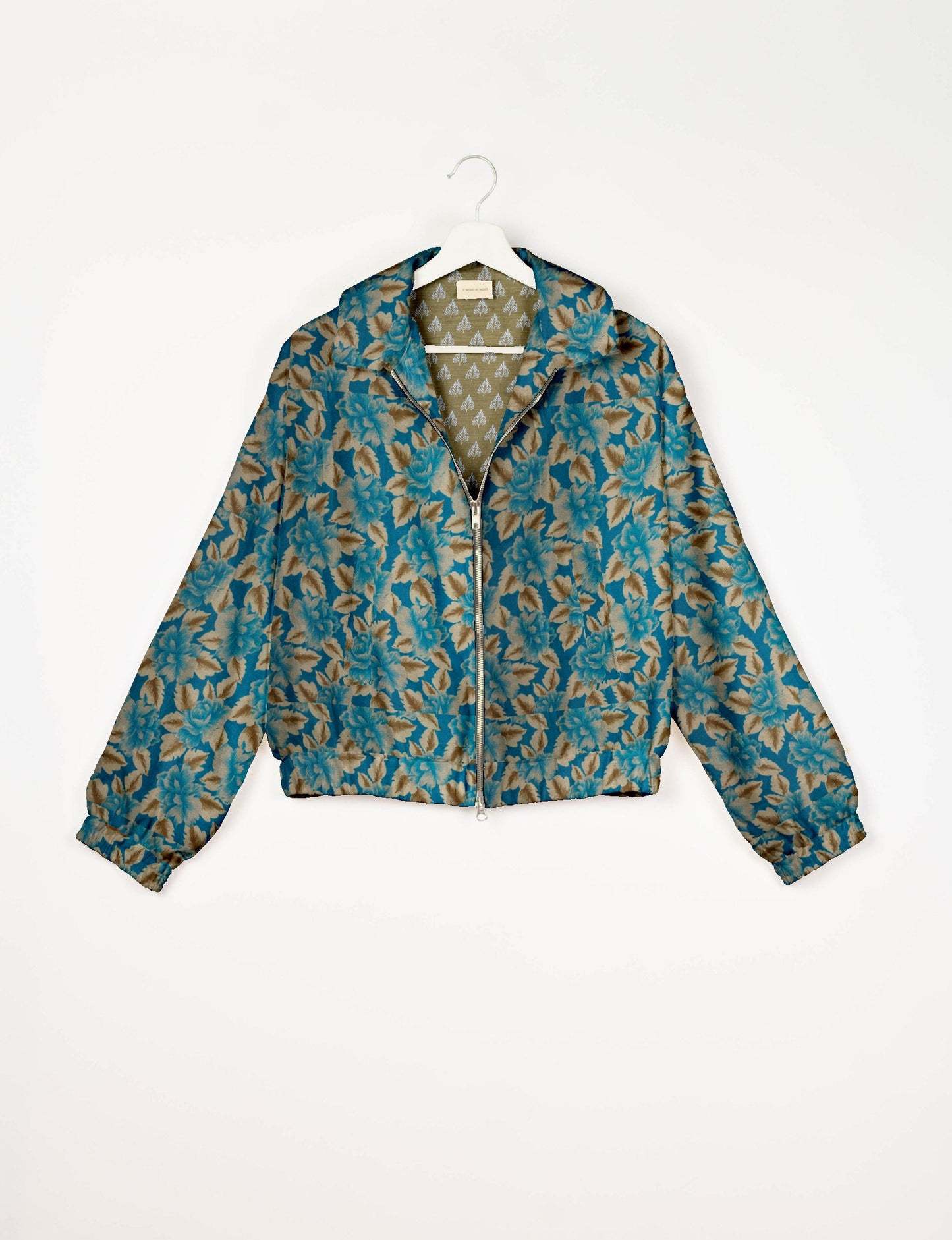 Upcycled Bomber Jacket made from recycled sari materials, featuring a cute cropped shape, elasticated hem and cuffs, and contrast sari print lining. Sustainable apparel promoting eco-friendly fashion and ethical clothing.