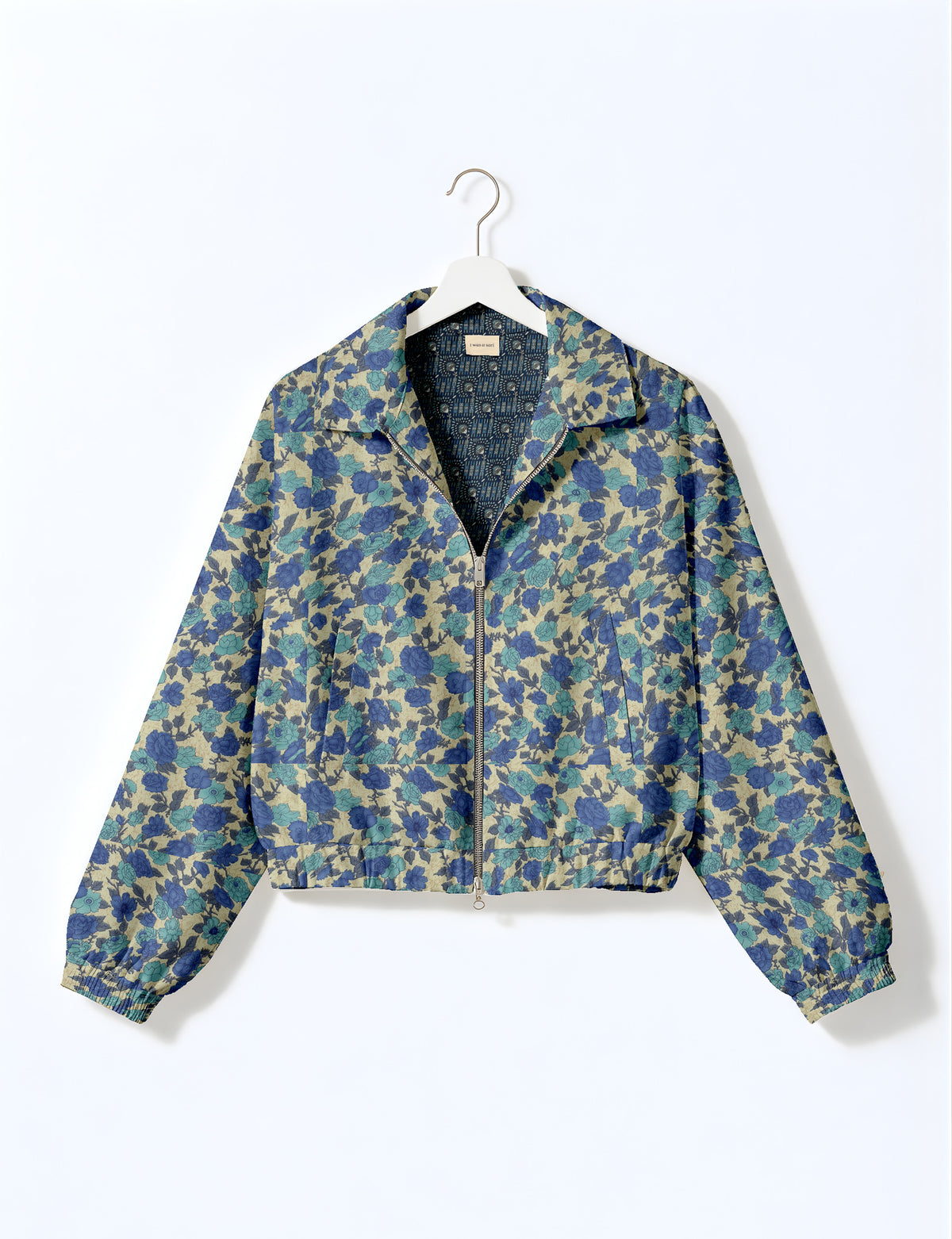 Woman wearing a yellow floral bomber jacket with front zipper, elastic cuffs, and side pockets, shown from front view