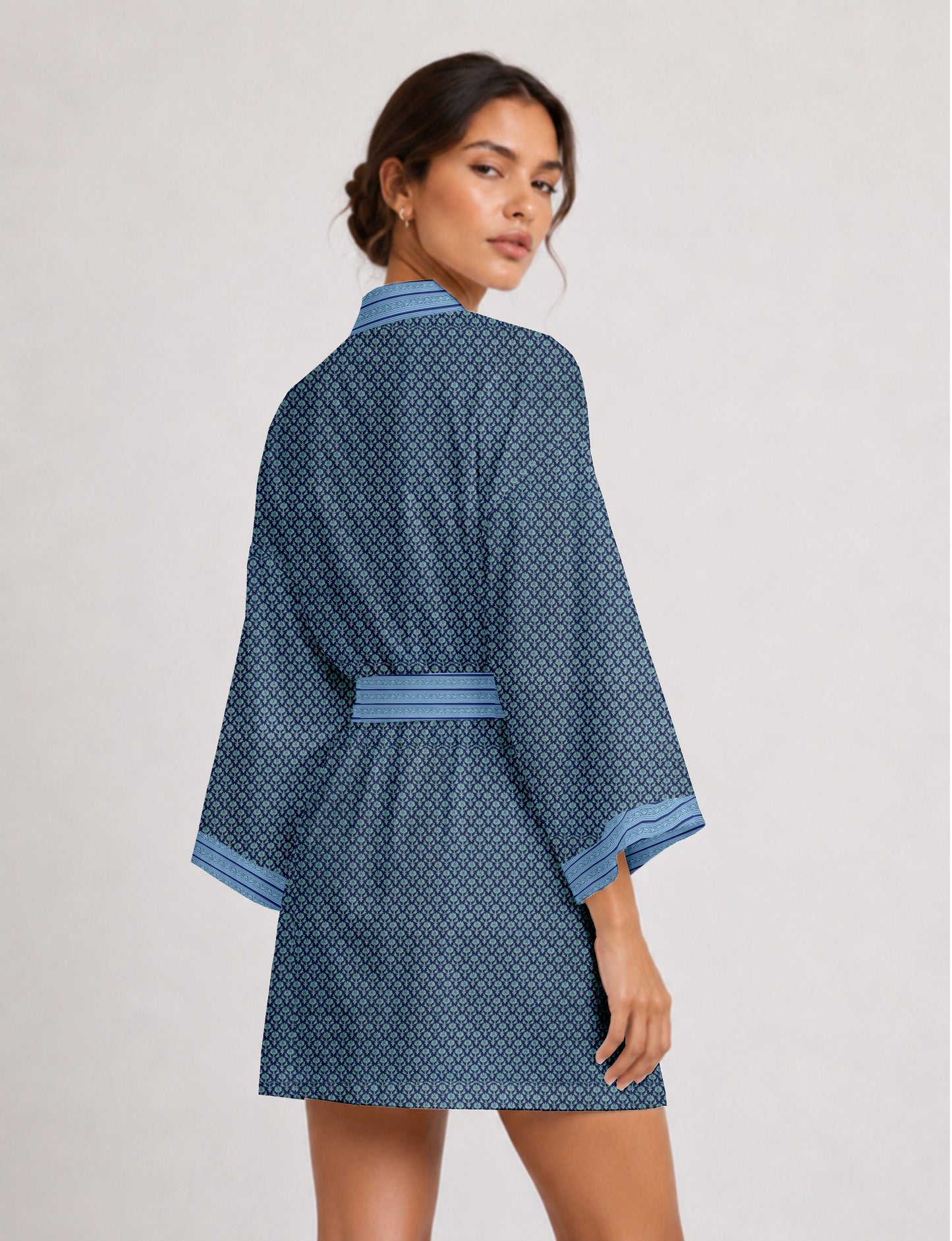 Short kimono robe with wrap front, V-neckline, wide sleeves, waist tie, and concealed skort detail.