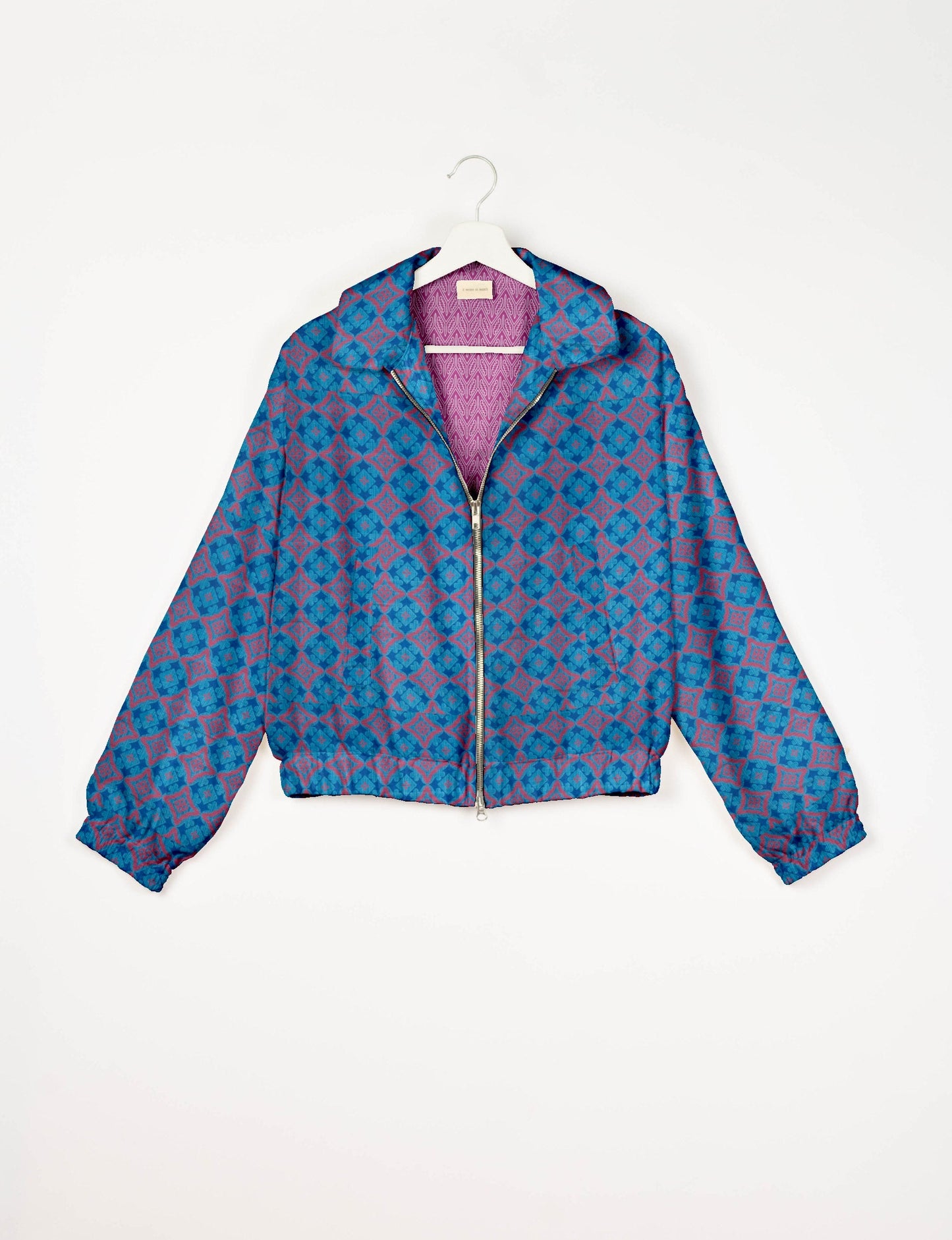 Upcycled Bomber Jacket made from recycled sari materials, featuring a cute cropped shape, elasticated hem and cuffs, and contrast sari print lining. Sustainable apparel promoting eco-friendly fashion and ethical clothing.