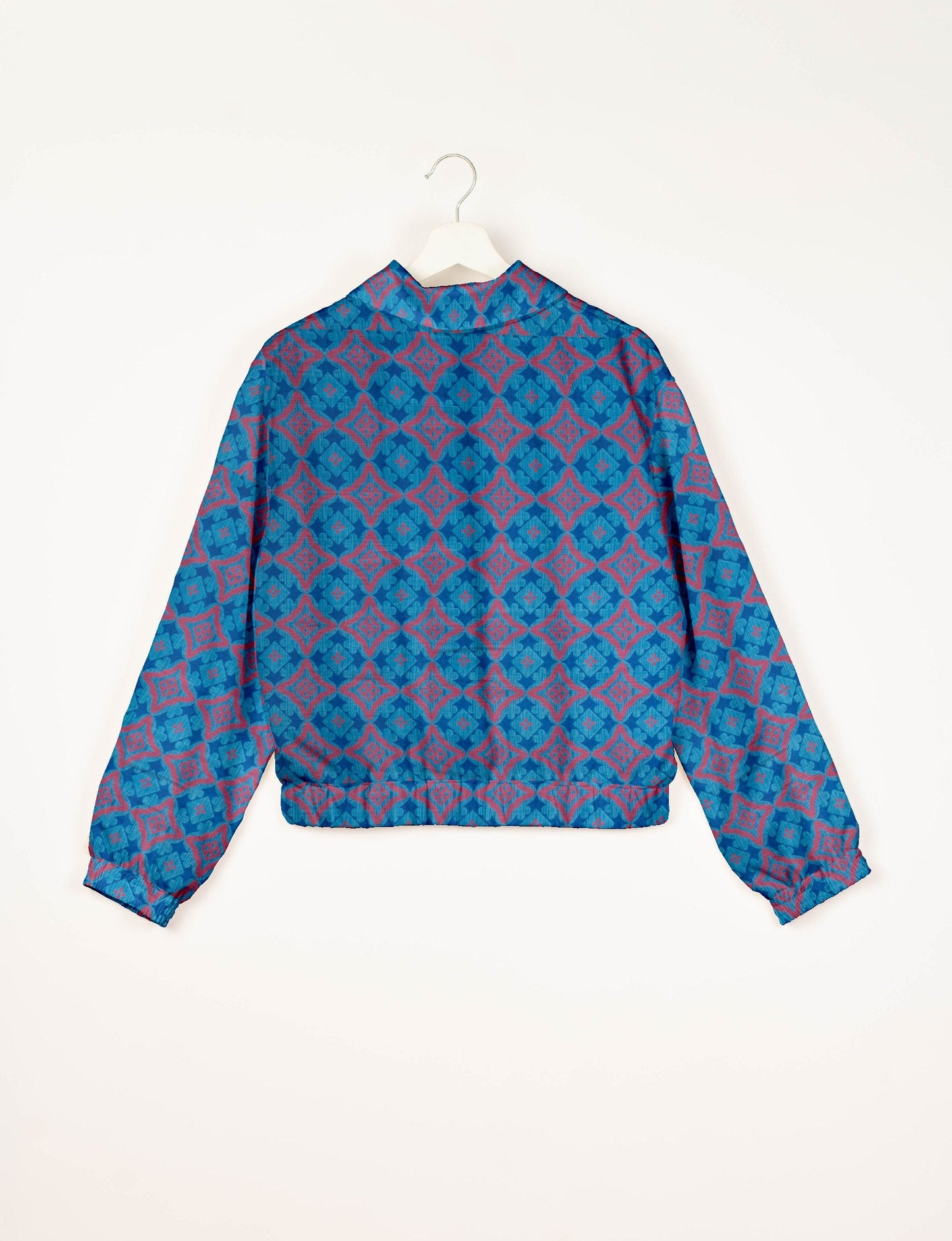Upcycled Bomber Jacket made from recycled sari materials, featuring a cute cropped shape, elasticated hem and cuffs, and contrast sari print lining. Sustainable apparel promoting eco-friendly fashion and ethical clothing.