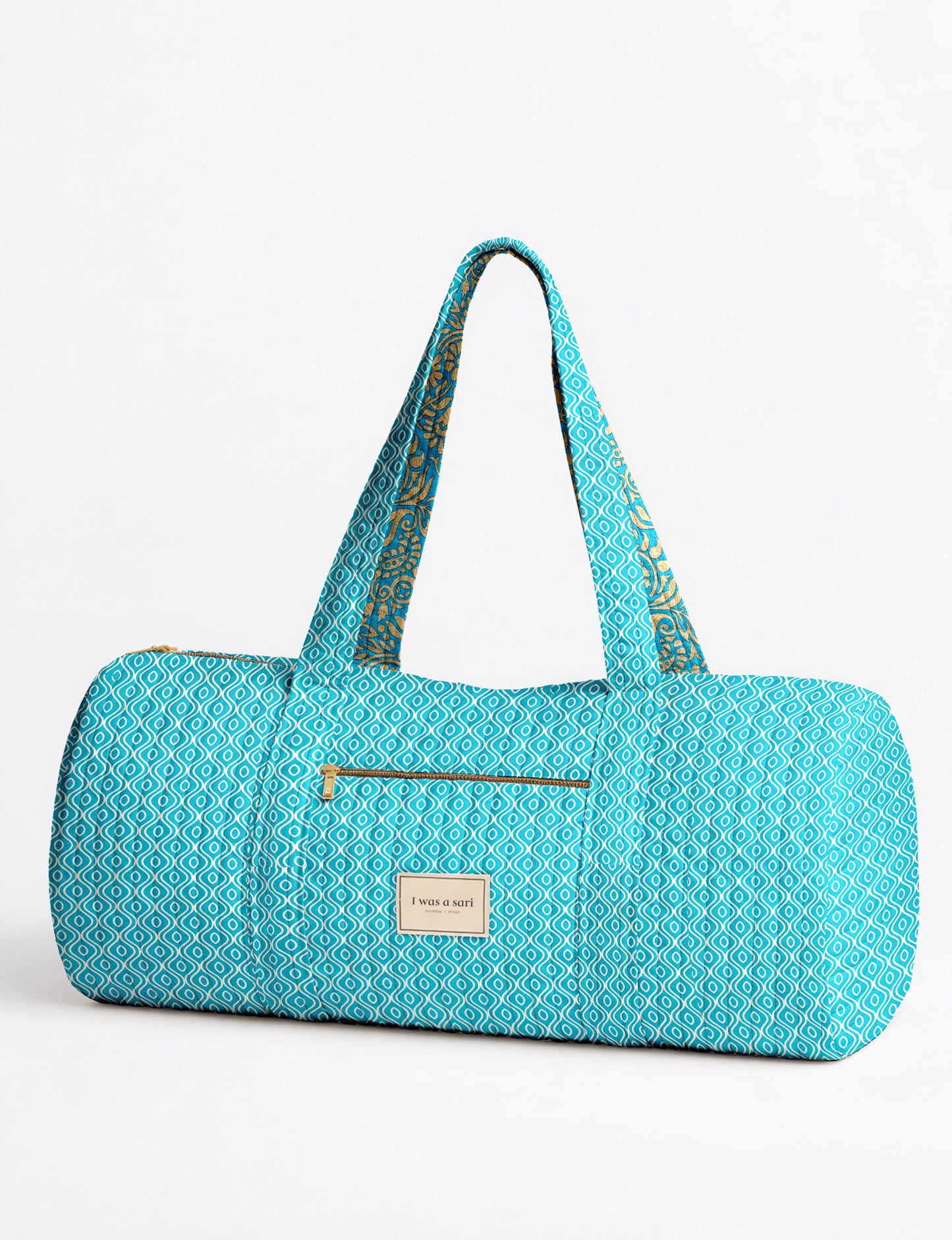 Brown paisley quilted bowling bag with dual handles, front zipper pocket, and "I was a sari" label on front side