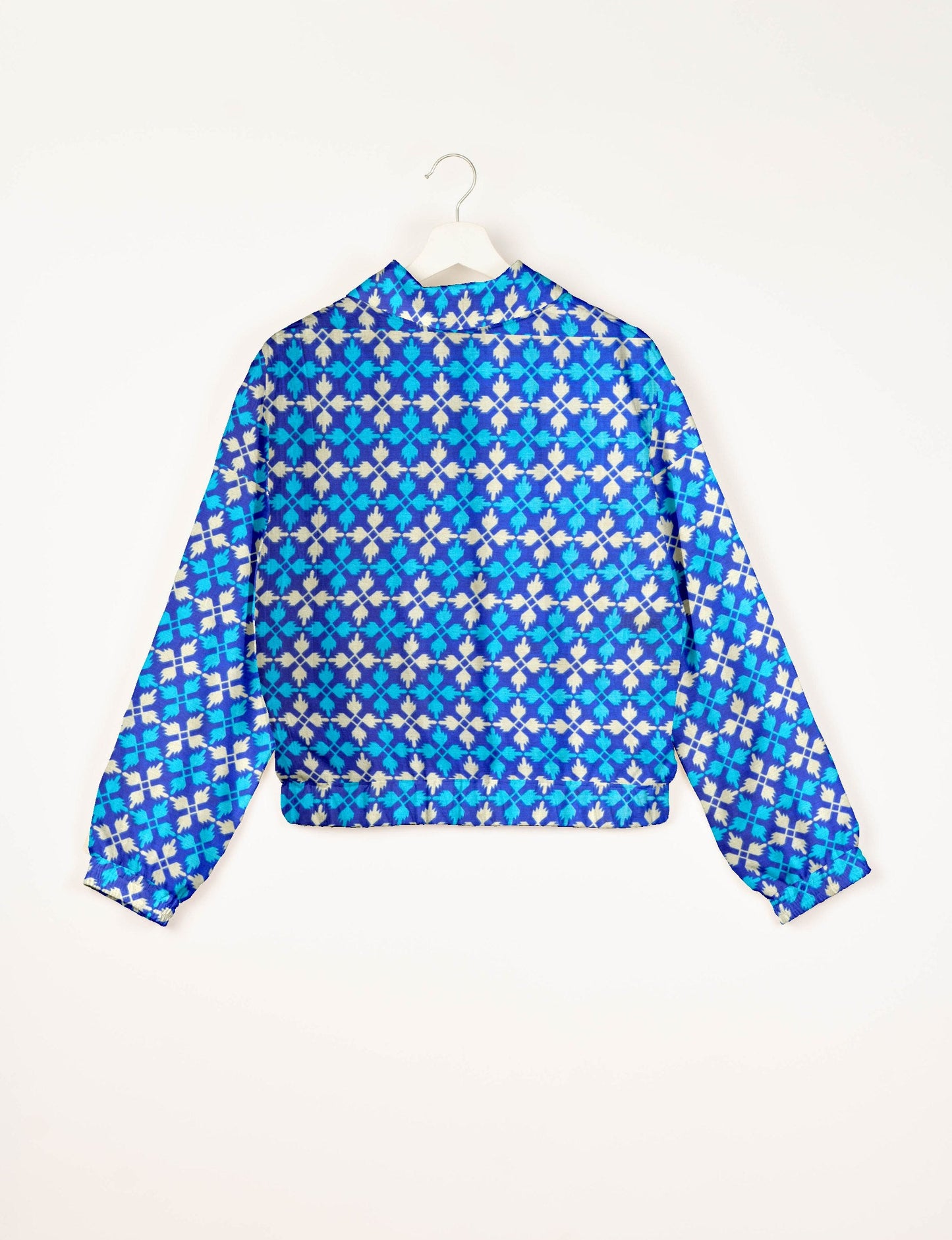 Upcycled Bomber Jacket made from recycled sari materials, featuring a cute cropped shape, elasticated hem and cuffs, and contrast sari print lining. Sustainable apparel promoting eco-friendly fashion and ethical clothing.
