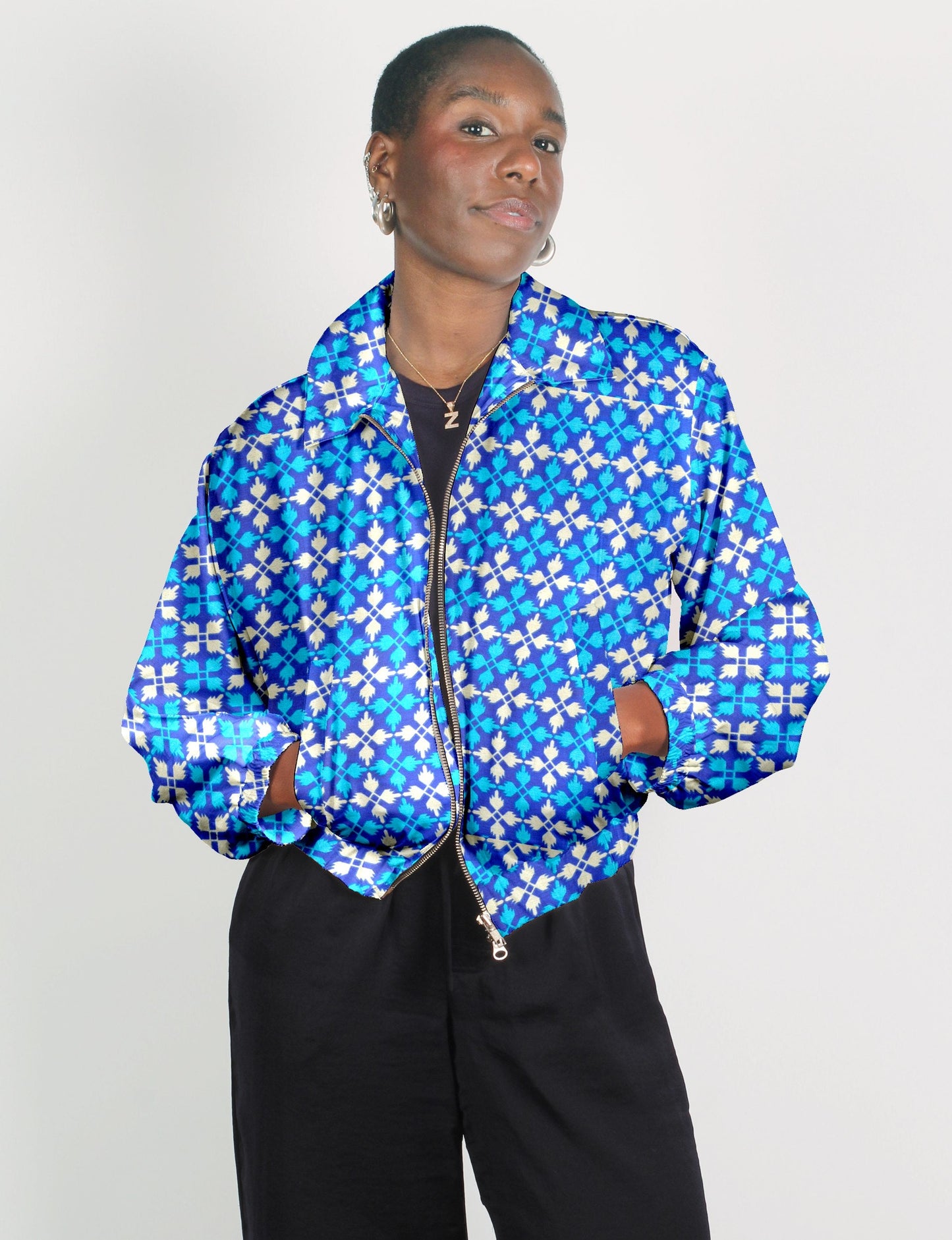 Upcycled Bomber Jacket made from recycled sari materials, featuring a cute cropped shape, elasticated hem and cuffs, and contrast sari print lining. Sustainable apparel promoting eco-friendly fashion and ethical clothing.