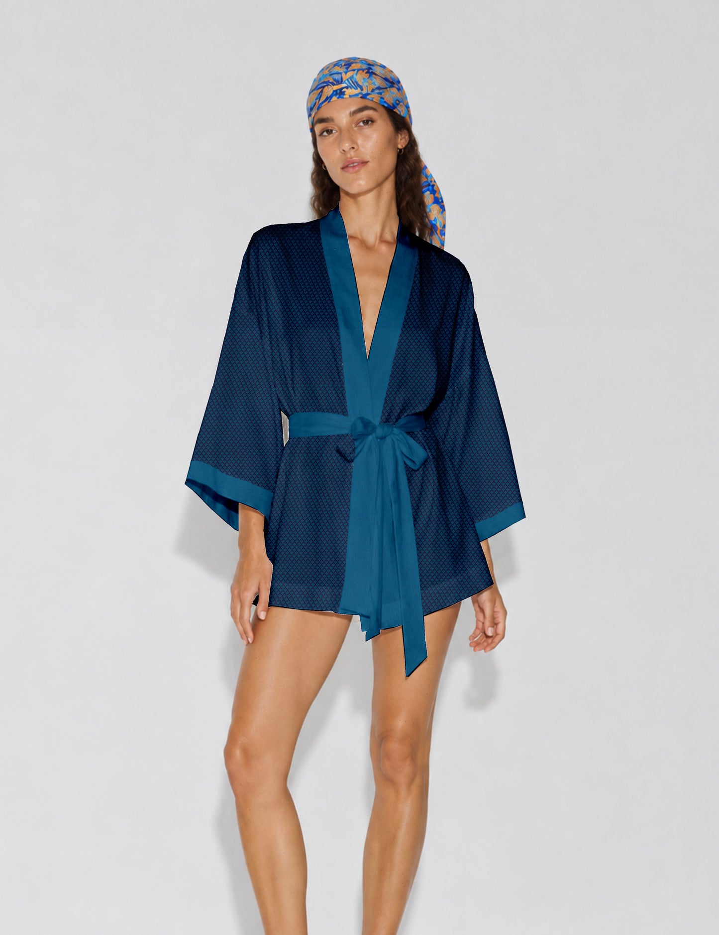 Short kimono robe with wrap front, V-neckline, wide sleeves, waist tie, and concealed skort detail.