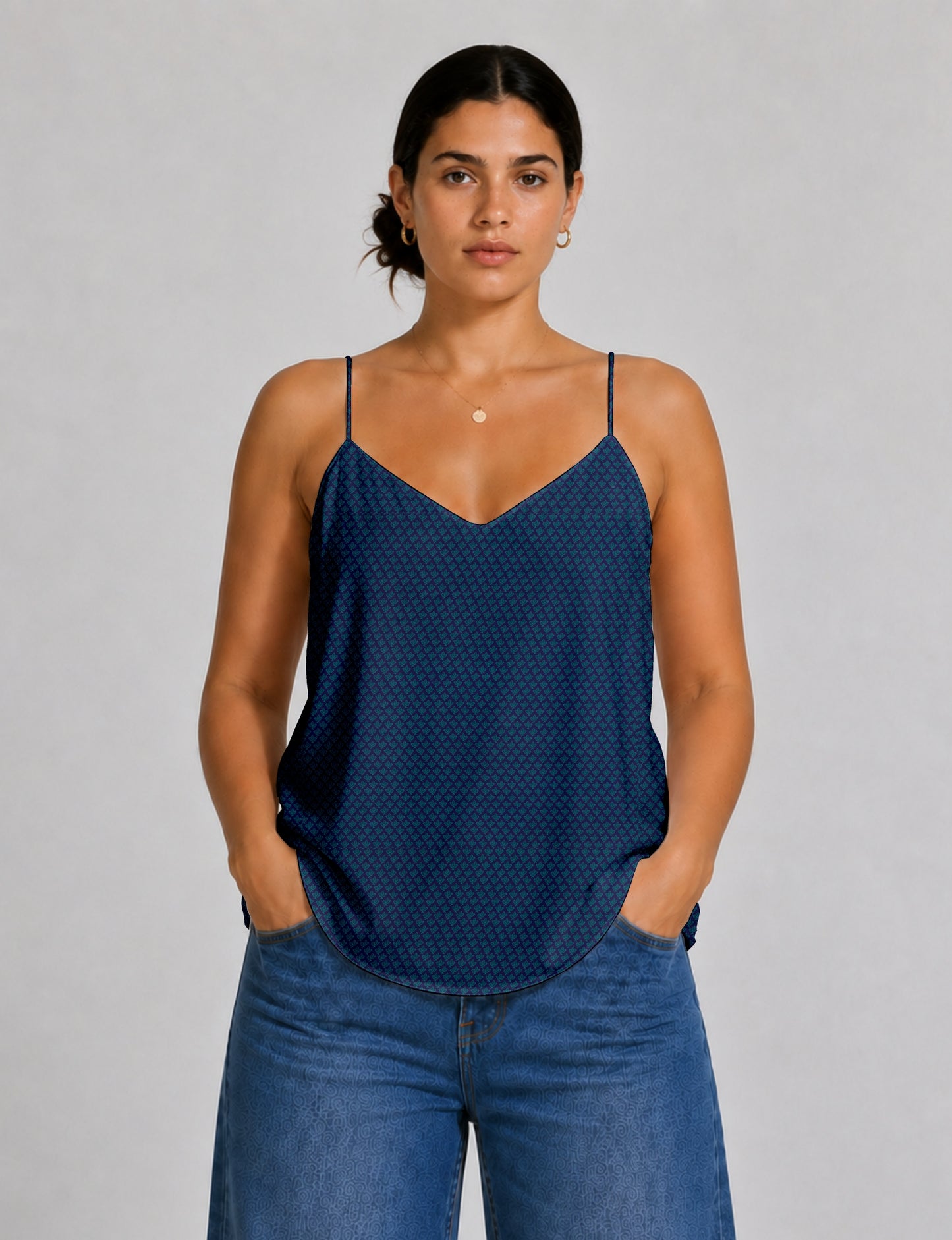 Women's sleeveless slip top with a relaxed straight fit, soft V-neckline, deep V-back, and delicate spaghetti straps.