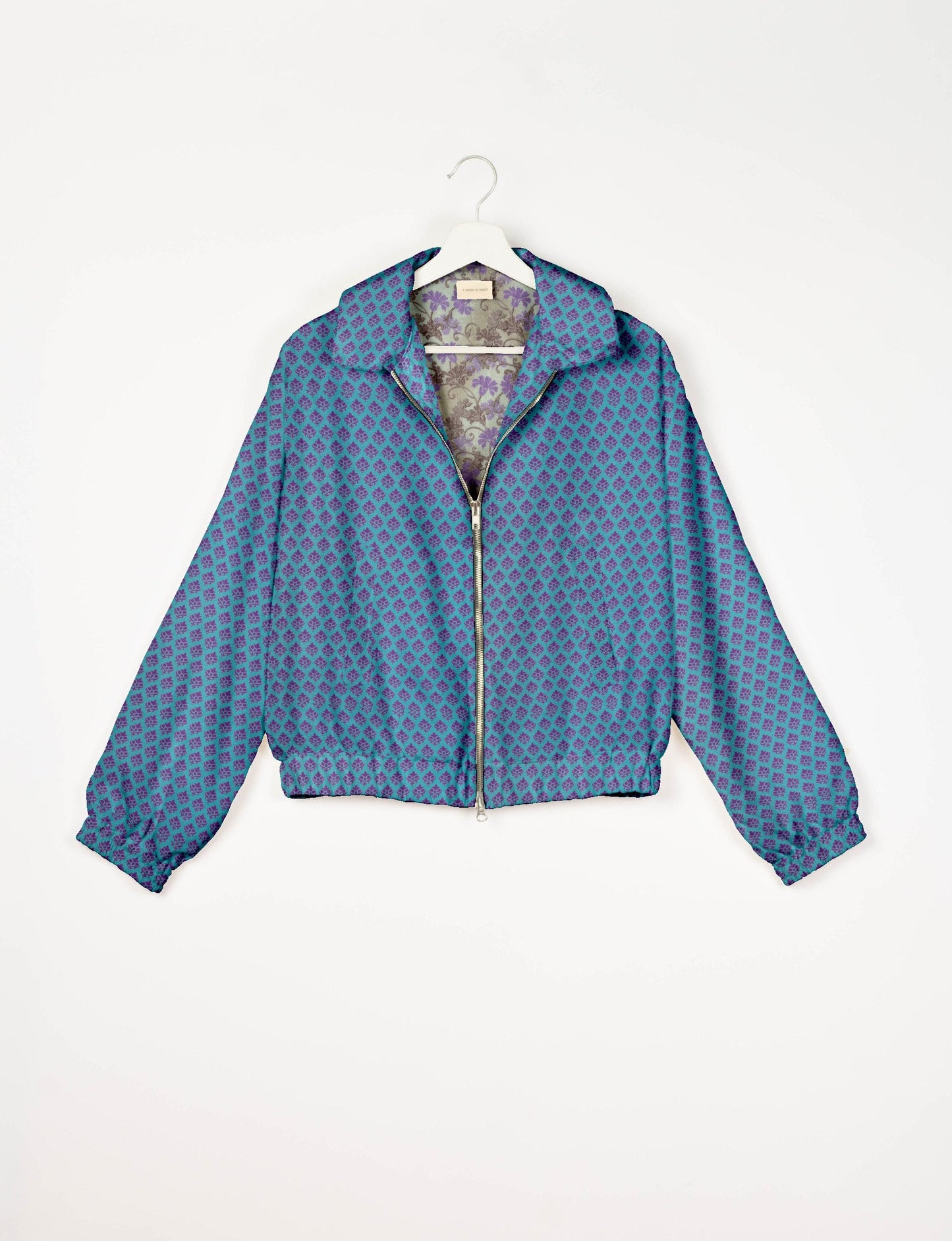 Upcycled Bomber Jacket made from recycled sari materials, featuring a cute cropped shape, elasticated hem and cuffs, and contrast sari print lining. Sustainable apparel promoting eco-friendly fashion and ethical clothing.