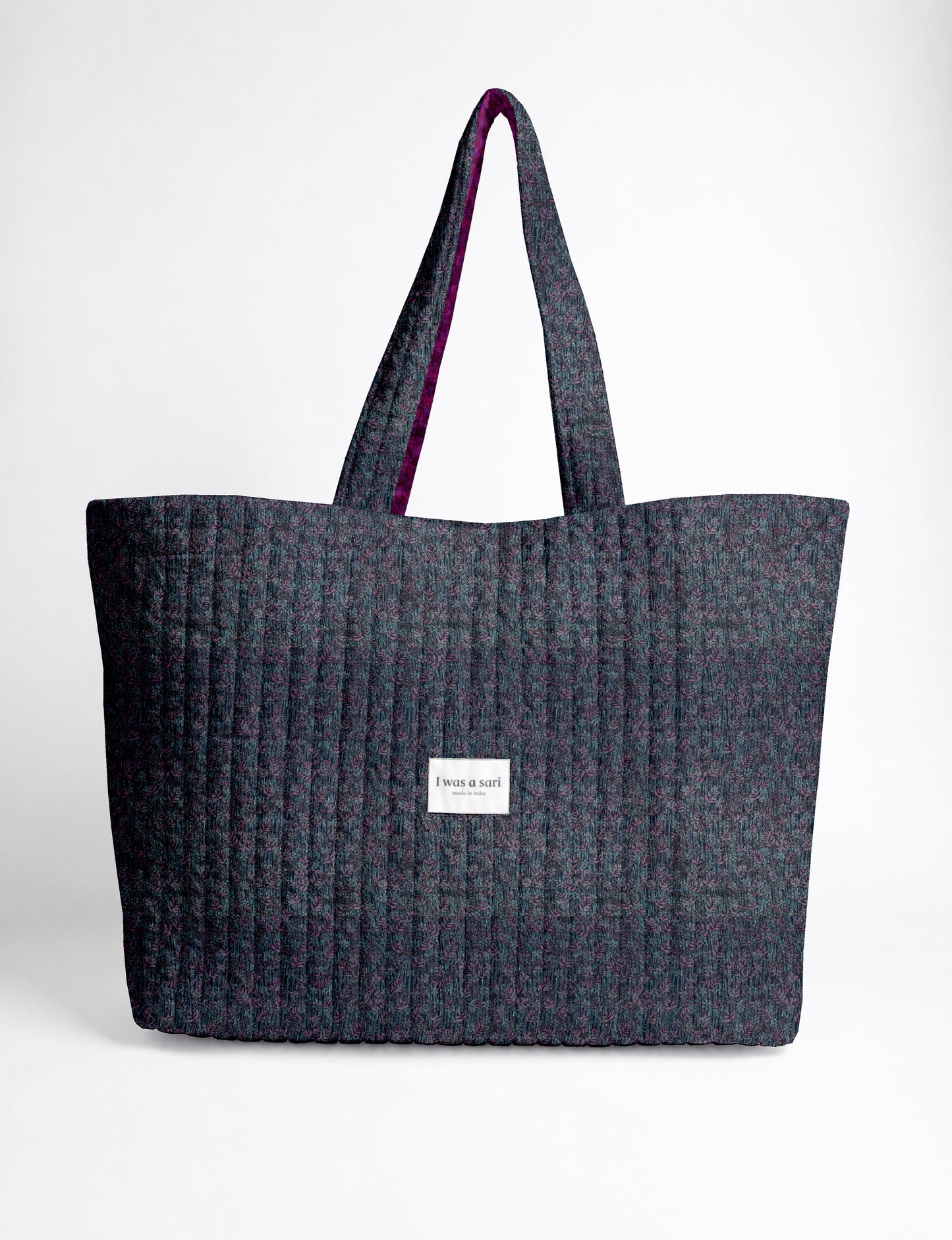 Large quilted beach bag with spacious rectangular design, reinforced shoulder straps, and open-top construction for everyday use and travel.