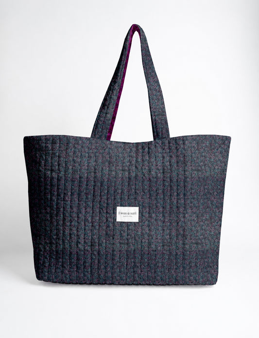 Large quilted beach bag with spacious rectangular design, reinforced shoulder straps, and open-top construction for everyday use and travel.