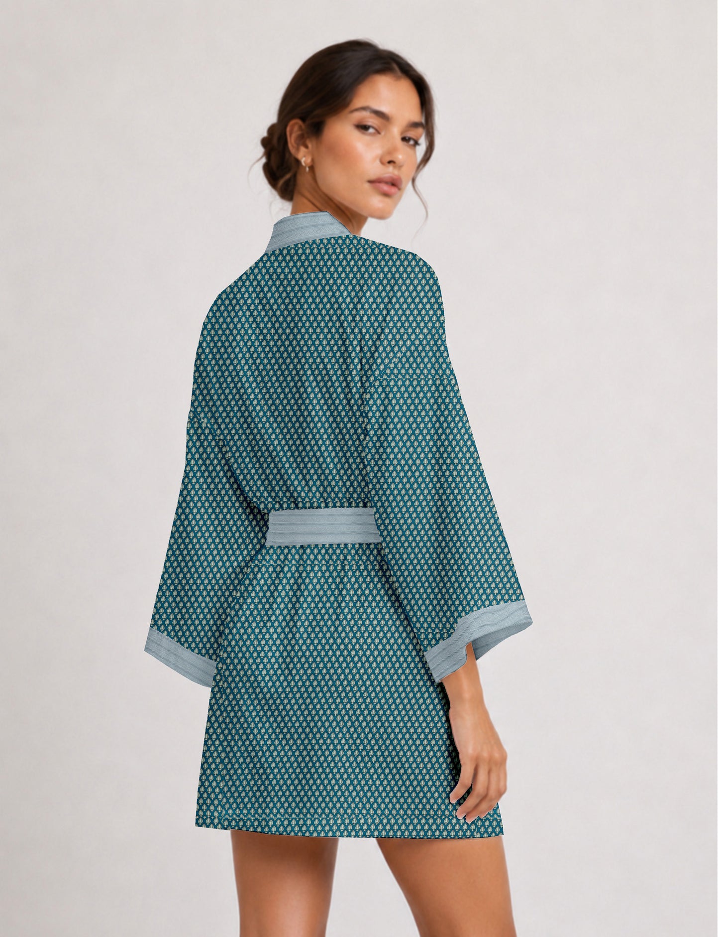 Short kimono robe with wrap front, V-neckline, wide sleeves, waist tie, and concealed skort detail.