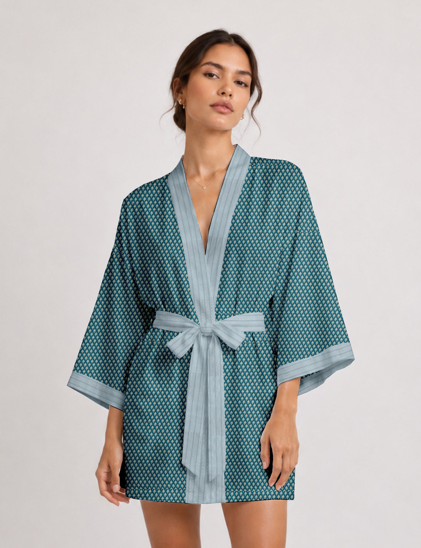 Short kimono robe with wrap front, V-neckline, wide sleeves, waist tie, and concealed skort detail.