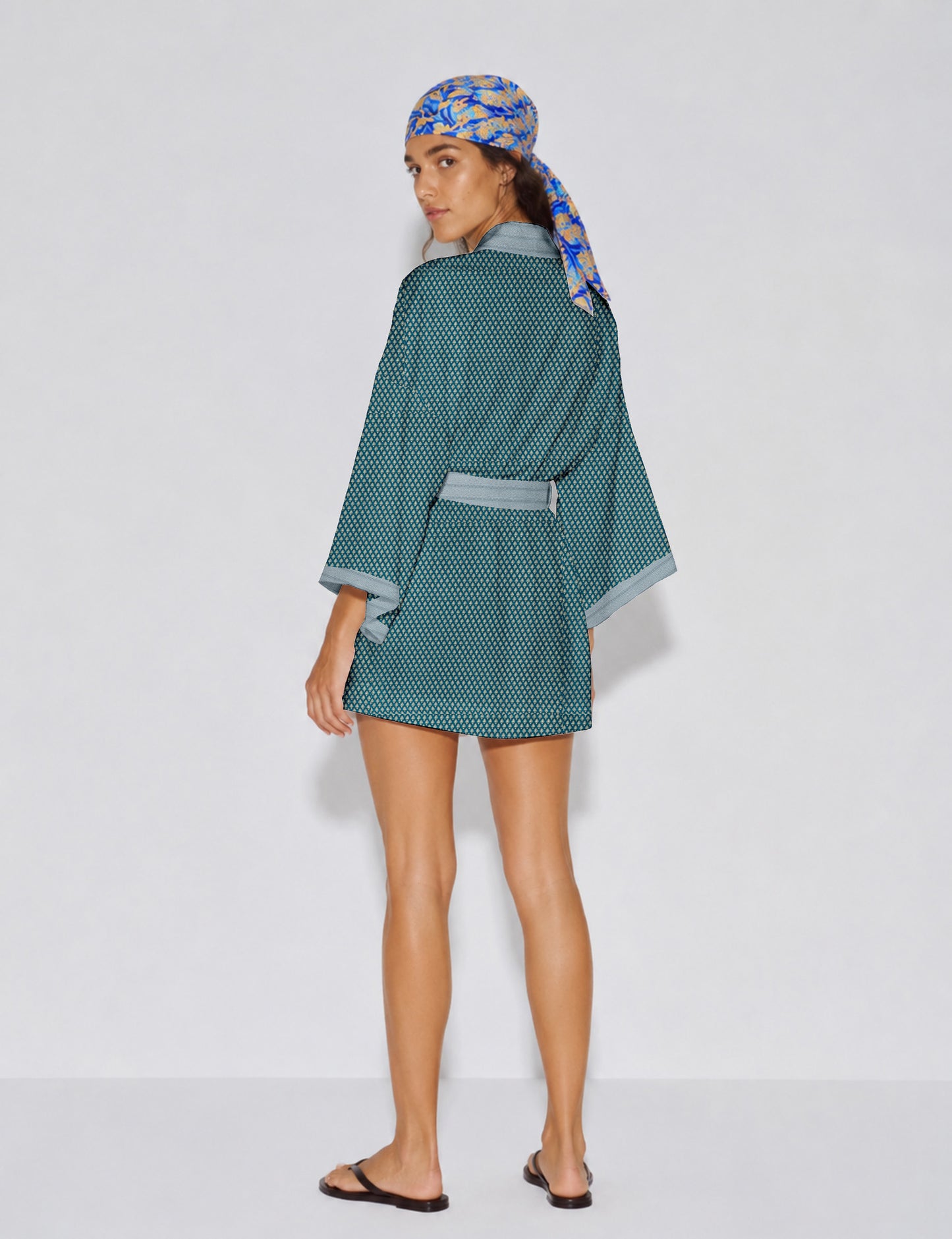 Short kimono robe with wrap front, V-neckline, wide sleeves, waist tie, and concealed skort detail.