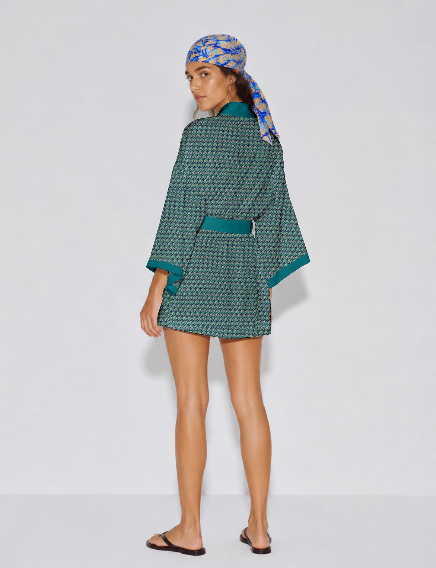 Short kimono robe with wrap front, V-neckline, wide sleeves, waist tie, and concealed skort detail.