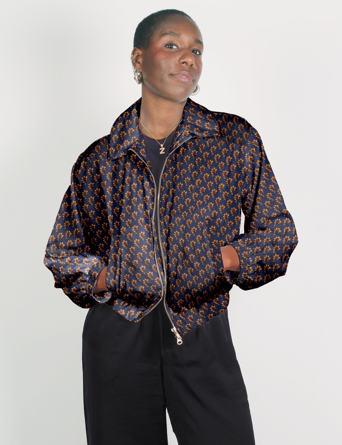 Upcycled Bomber Jacket made from recycled sari materials, featuring a cute cropped shape, elasticated hem and cuffs, and contrast sari print lining. Sustainable apparel promoting eco-friendly fashion and ethical clothing.