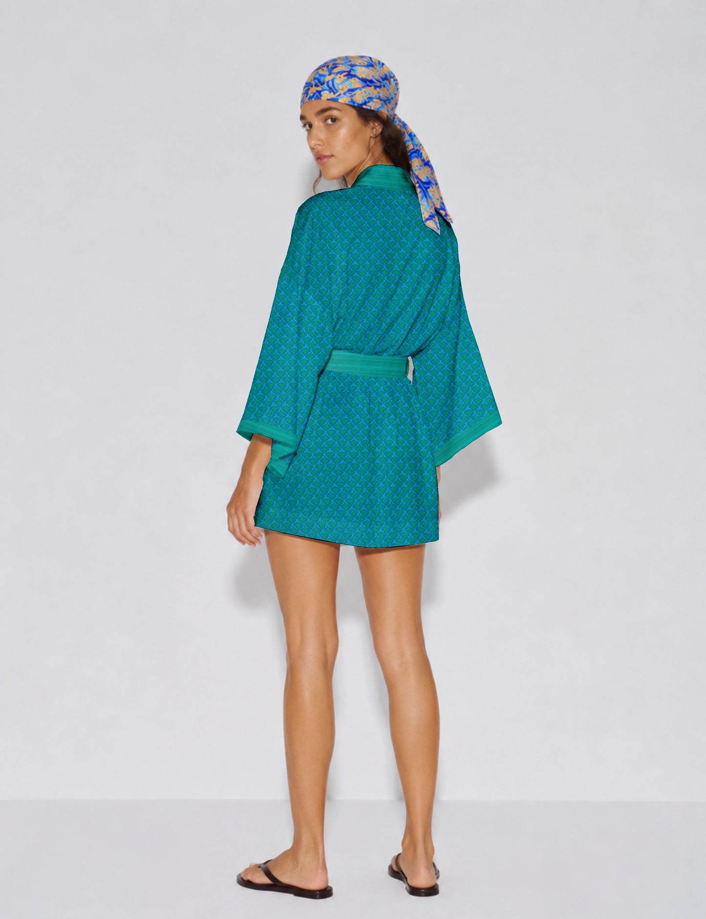 Short kimono robe with wrap front, V-neckline, wide sleeves, waist tie, and concealed skort detail.