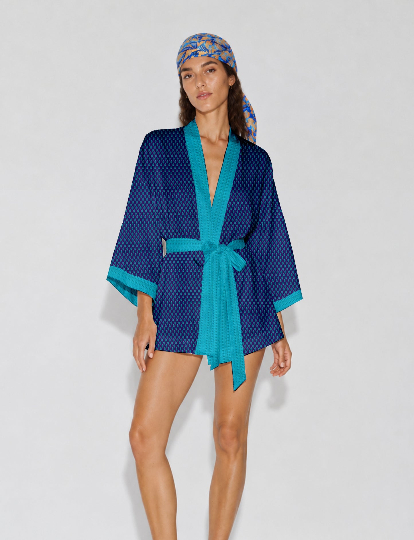 Short kimono robe with wrap front, V-neckline, wide sleeves, waist tie, and concealed skort detail.