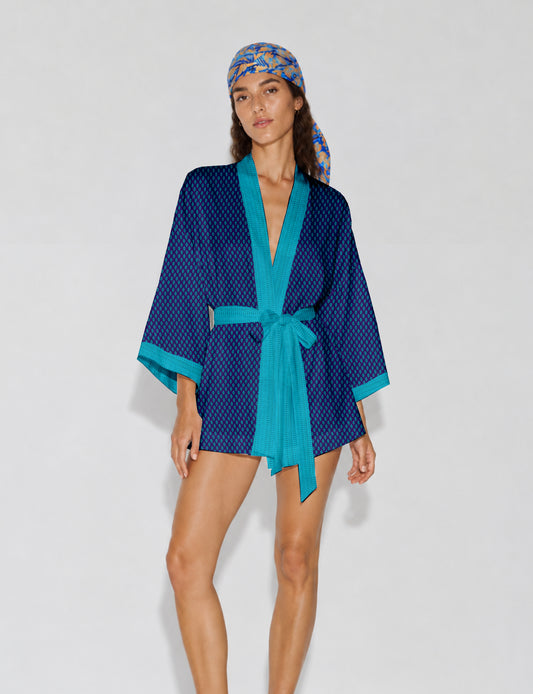Short kimono robe with wrap front, V-neckline, wide sleeves, waist tie, and concealed skort detail.