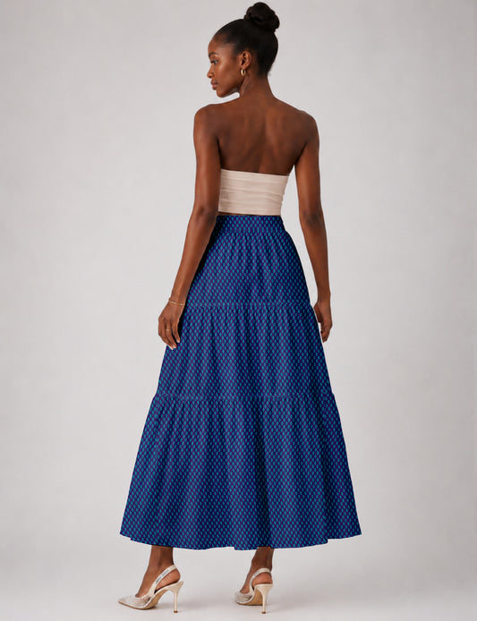 Midi tiered skirt with fitted waistband, soft knife pleats, flared silhouette, side seam pockets, and ankle-length hem