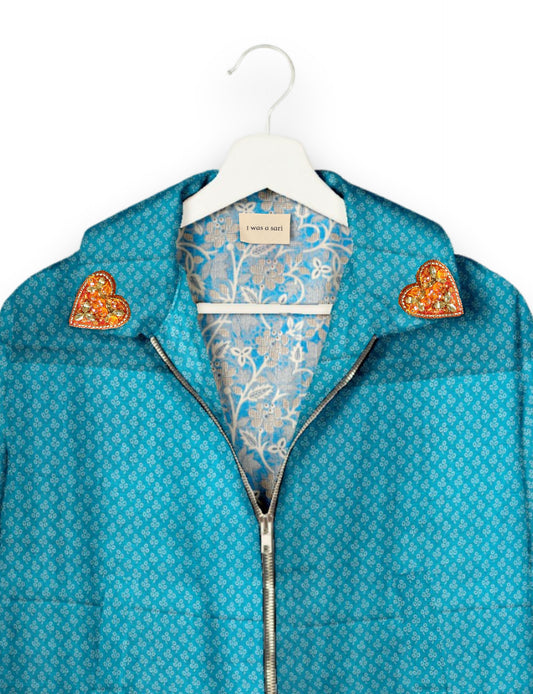 Make a bold statement with our Heart Drop Earrings, a symbol of conscious luxury and ethical fashion. Handcrafted using the intricate Aari embroidery technique, these earrings are made from upcycled sari fabric, embracing slow fashion and zero waste clothing. Elevate your look with sustainable apparel that supports fair trade fashion while reducing textile waste. Choose eco-friendly fashion that speaks of love, artistry, and responsibility.