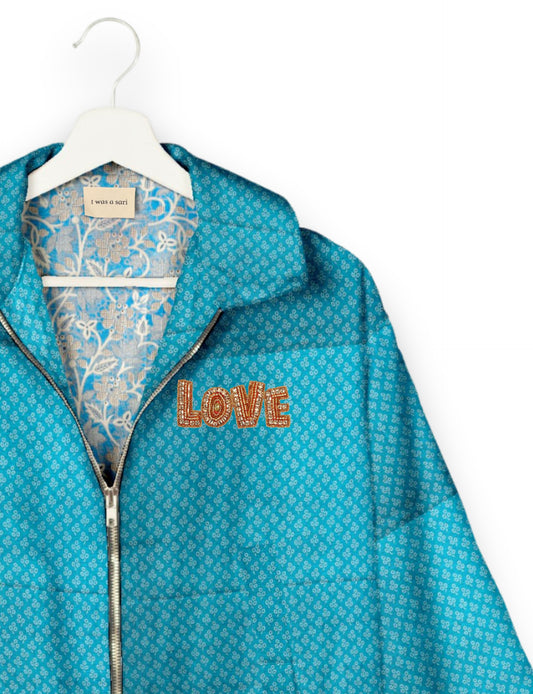 Love Bomber Jacket made from recycled fabric, featuring hand-stitched Aari embroidery. A unique piece of zero-waste clothing, part of the circular fashion movement. Designed with upcycled materials for a stylish yet environmentally friendly clothing choice.