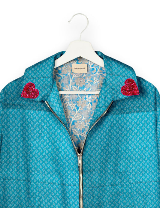 Make a bold statement with our Heart Drop Earrings, a symbol of conscious luxury and ethical fashion. Handcrafted using the intricate Aari embroidery technique, these earrings are made from upcycled sari fabric, embracing slow fashion and zero waste clothing. Elevate your look with sustainable apparel that supports fair trade fashion while reducing textile waste. Choose eco-friendly fashion that speaks of love, artistry, and responsibility.