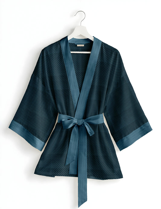 Short kimono robe with wrap front, V-neckline, wide sleeves, waist tie, and concealed skort detail.