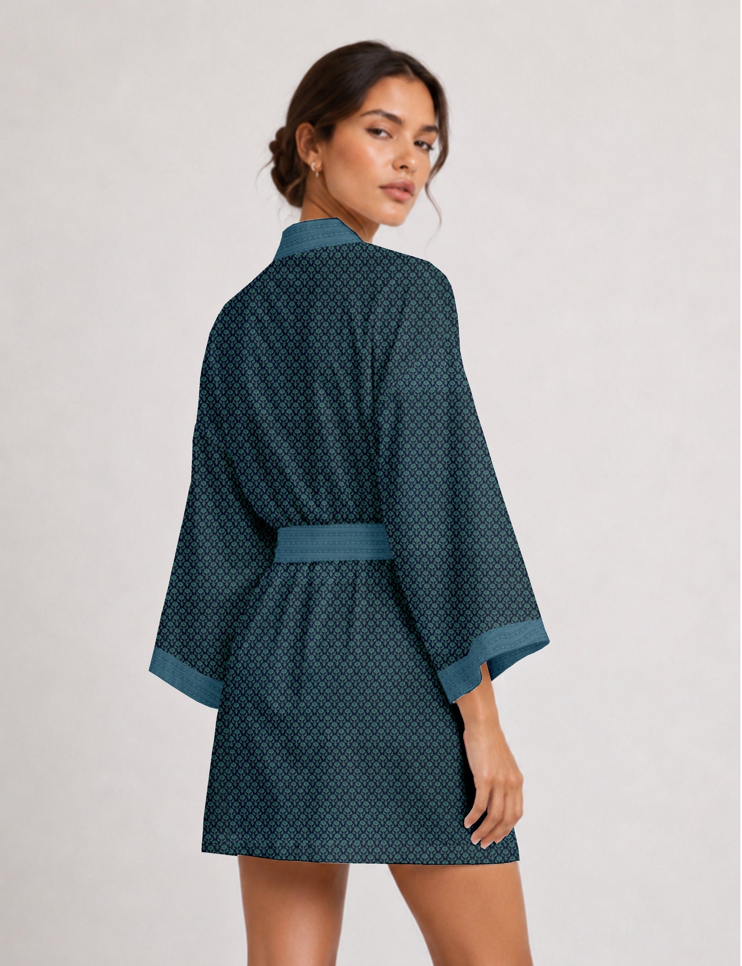 Short kimono robe with wrap front, V-neckline, wide sleeves, waist tie, and concealed skort detail.