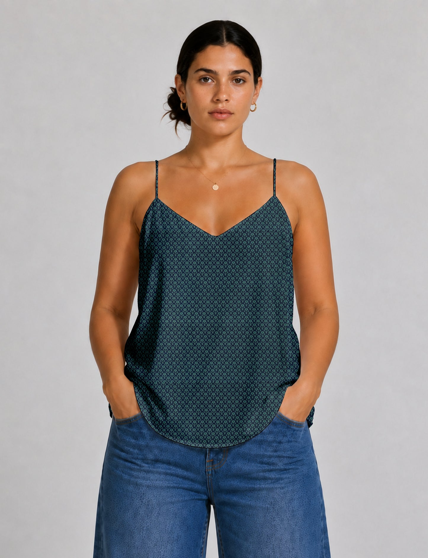 Women's sleeveless slip top with a relaxed straight fit, soft V-neckline, deep V-back, and delicate spaghetti straps.