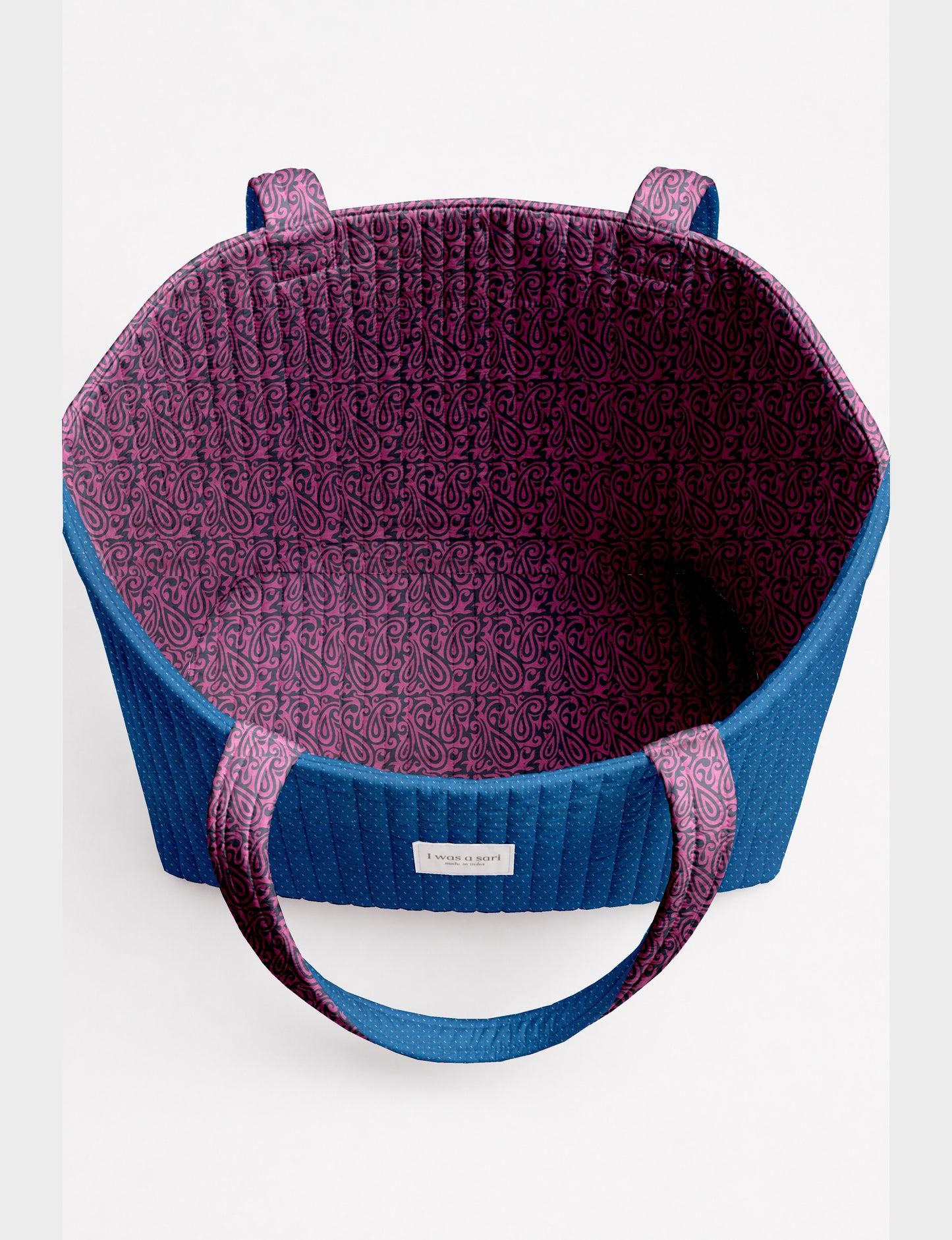 Large quilted beach bag with spacious rectangular design, reinforced shoulder straps, and open-top construction for everyday use and travel.