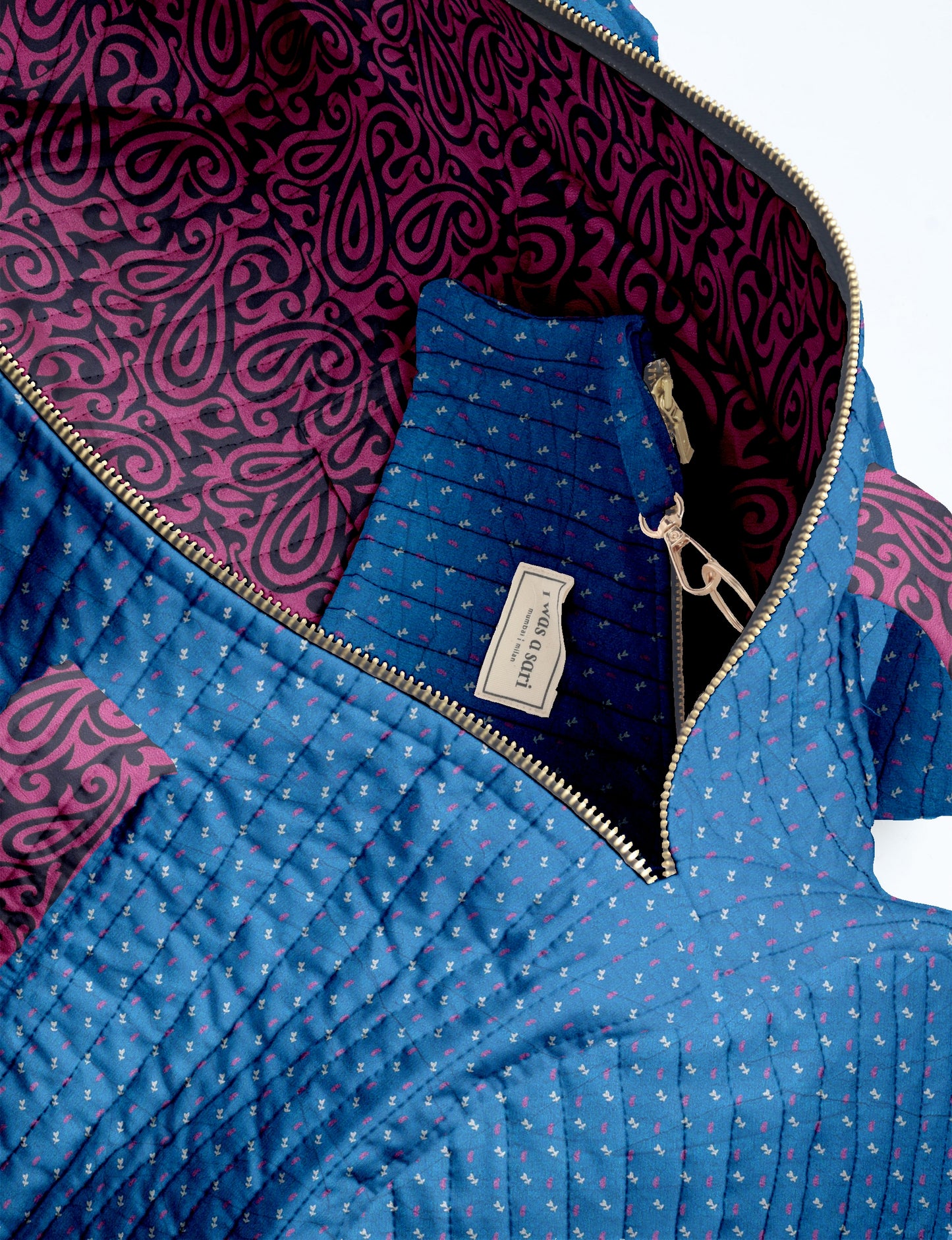 Woman wearing light blue jeans and white sneakers holding a beige quilted bowling bag with micro floral design and front